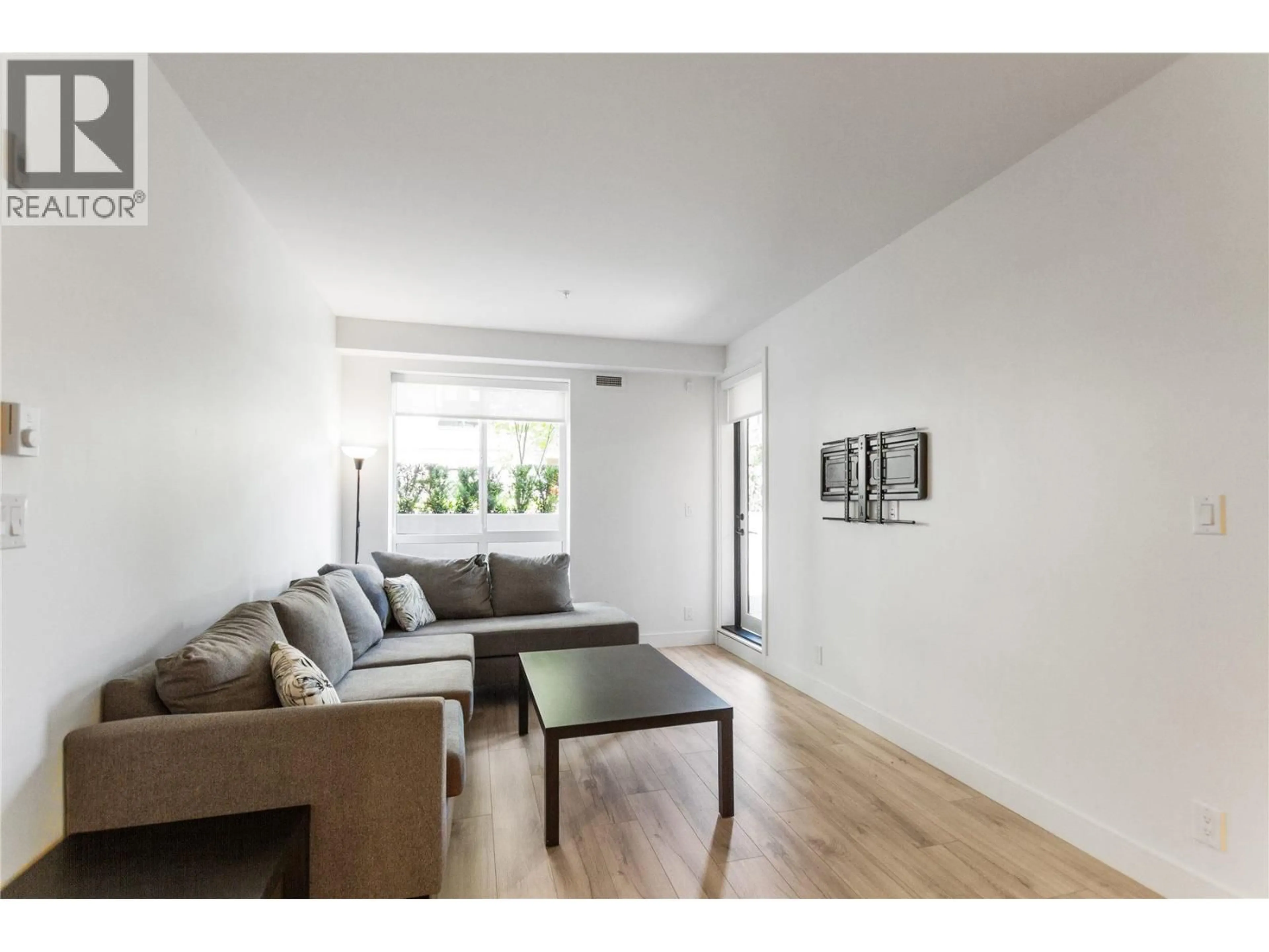 Living room with furniture, wood/laminate floor for 202 - 3131 MURRAY STREET, Port Moody British Columbia V3H0L9