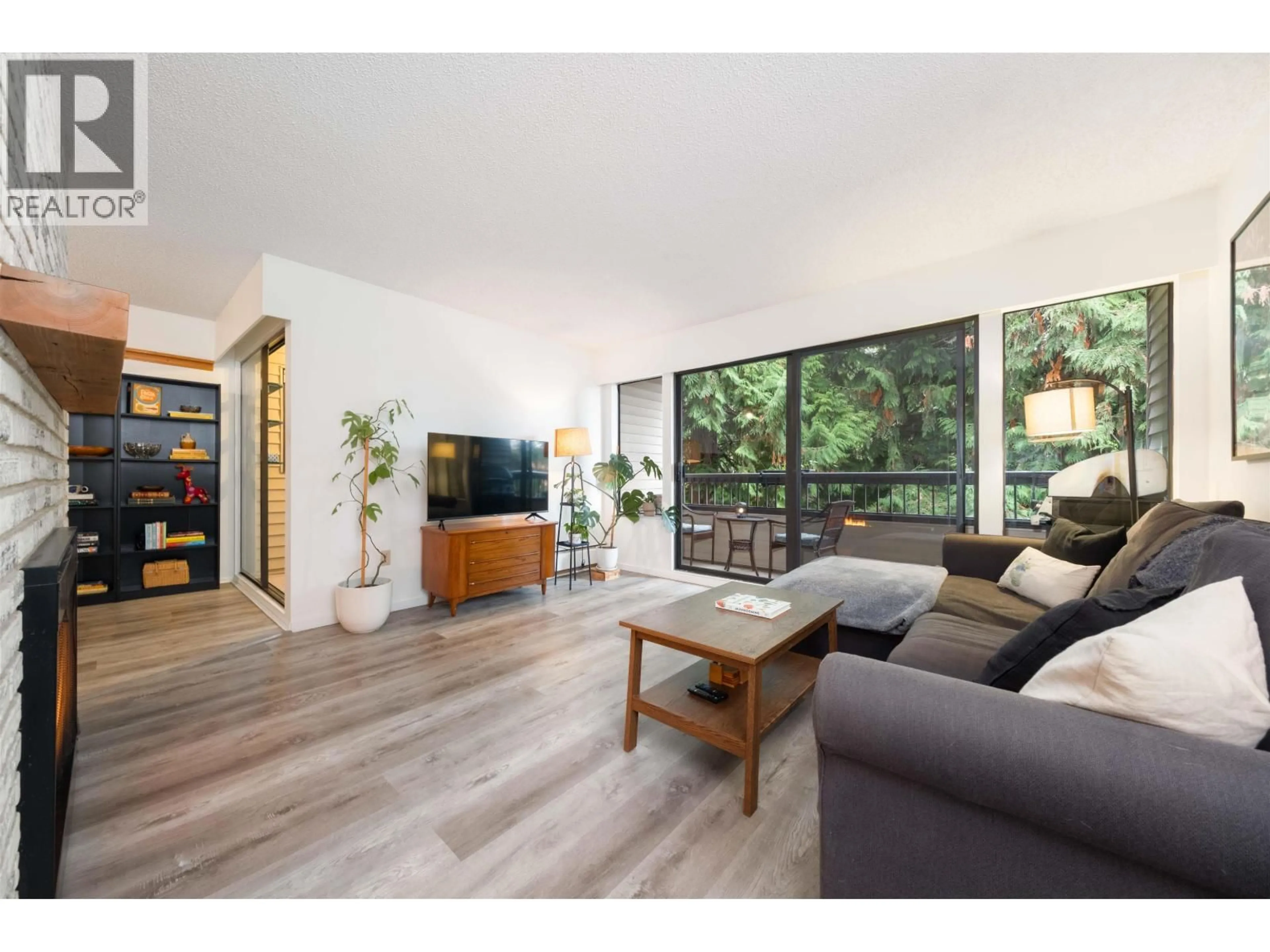 Living room with furniture, wood/laminate floor for 207 - 1048 KING ALBERT AVENUE, Coquitlam British Columbia V3J1X5