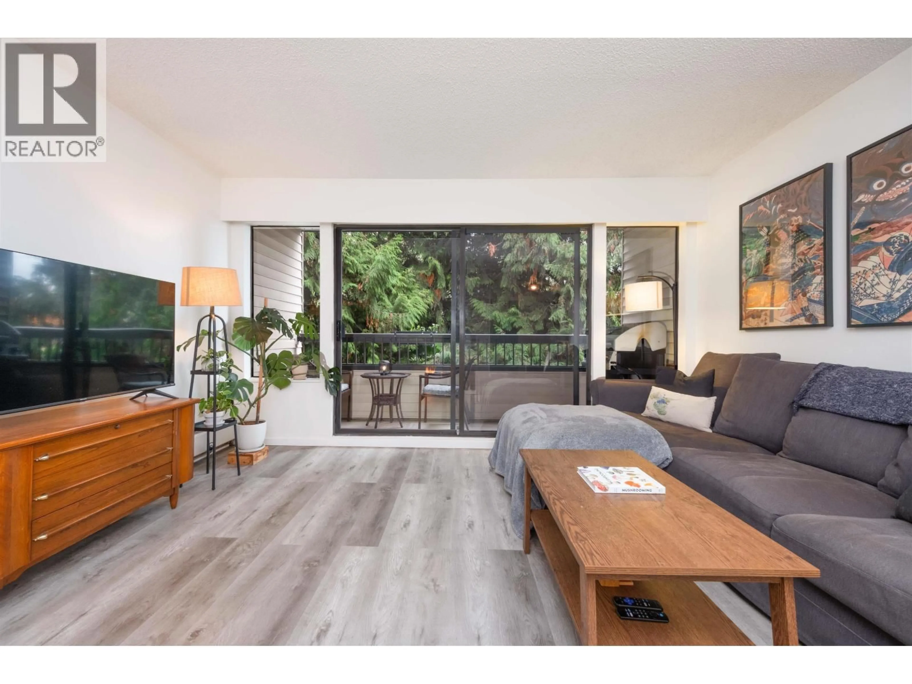 Living room with furniture, wood/laminate floor for 207 - 1048 KING ALBERT AVENUE, Coquitlam British Columbia V3J1X5