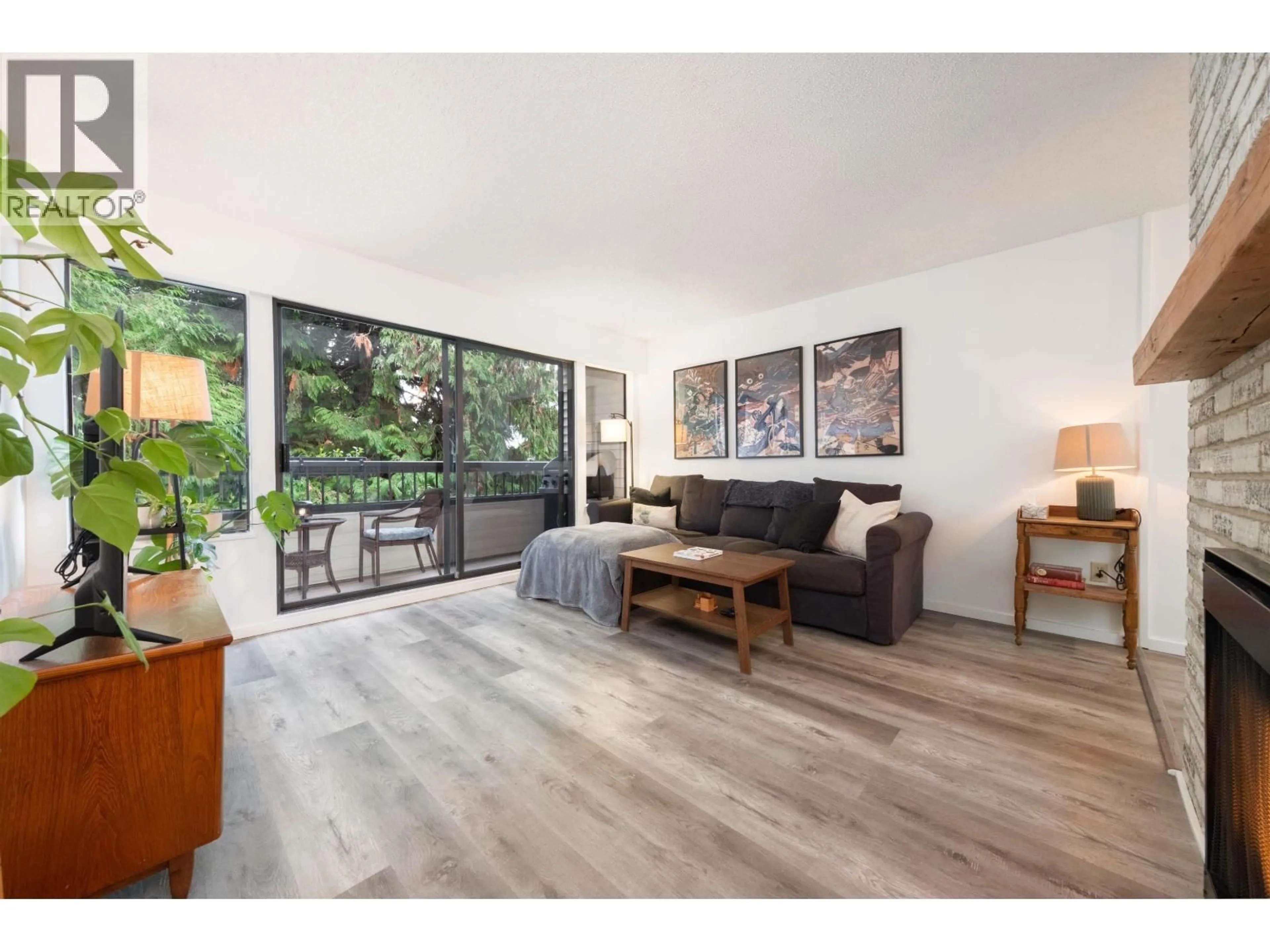 Living room with furniture, wood/laminate floor for 207 - 1048 KING ALBERT AVENUE, Coquitlam British Columbia V3J1X5