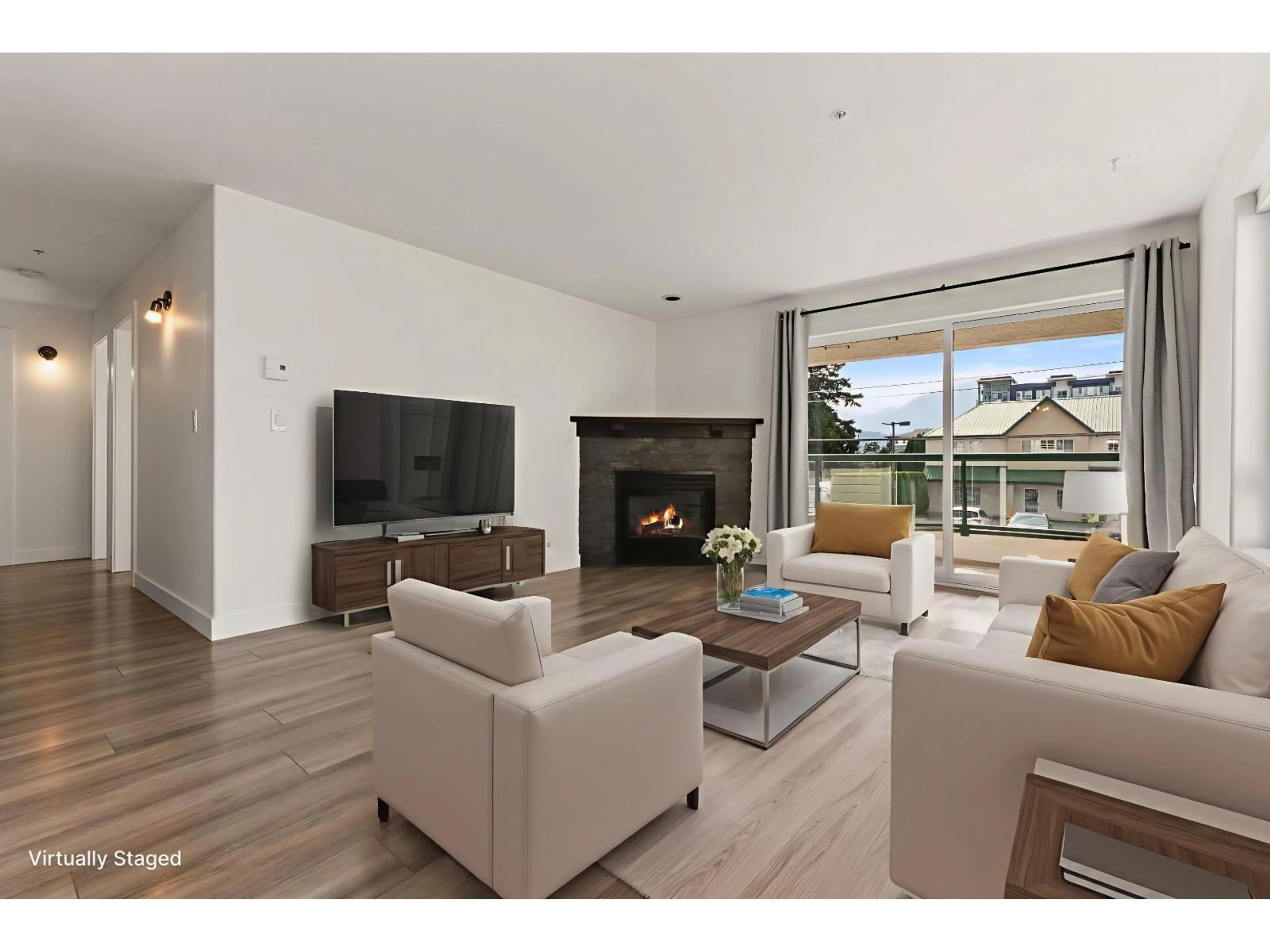 Living room with furniture, wood/laminate floor for 201 - 7415 SHAW AVENUE, Chilliwack British Columbia V2R3C1