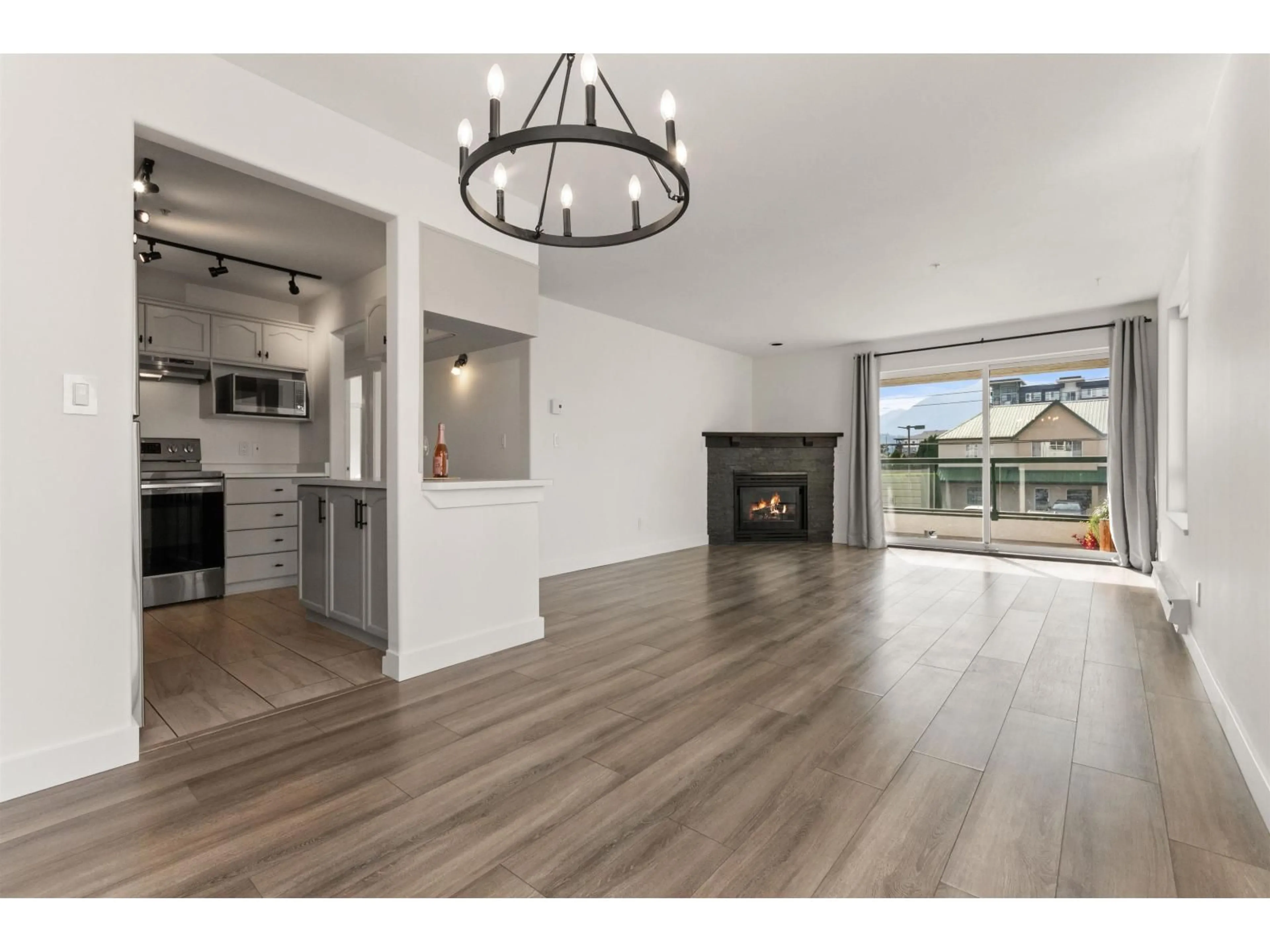 Open concept kitchen, wood/laminate floor for 201 - 7415 SHAW AVENUE, Chilliwack British Columbia V2R3C1