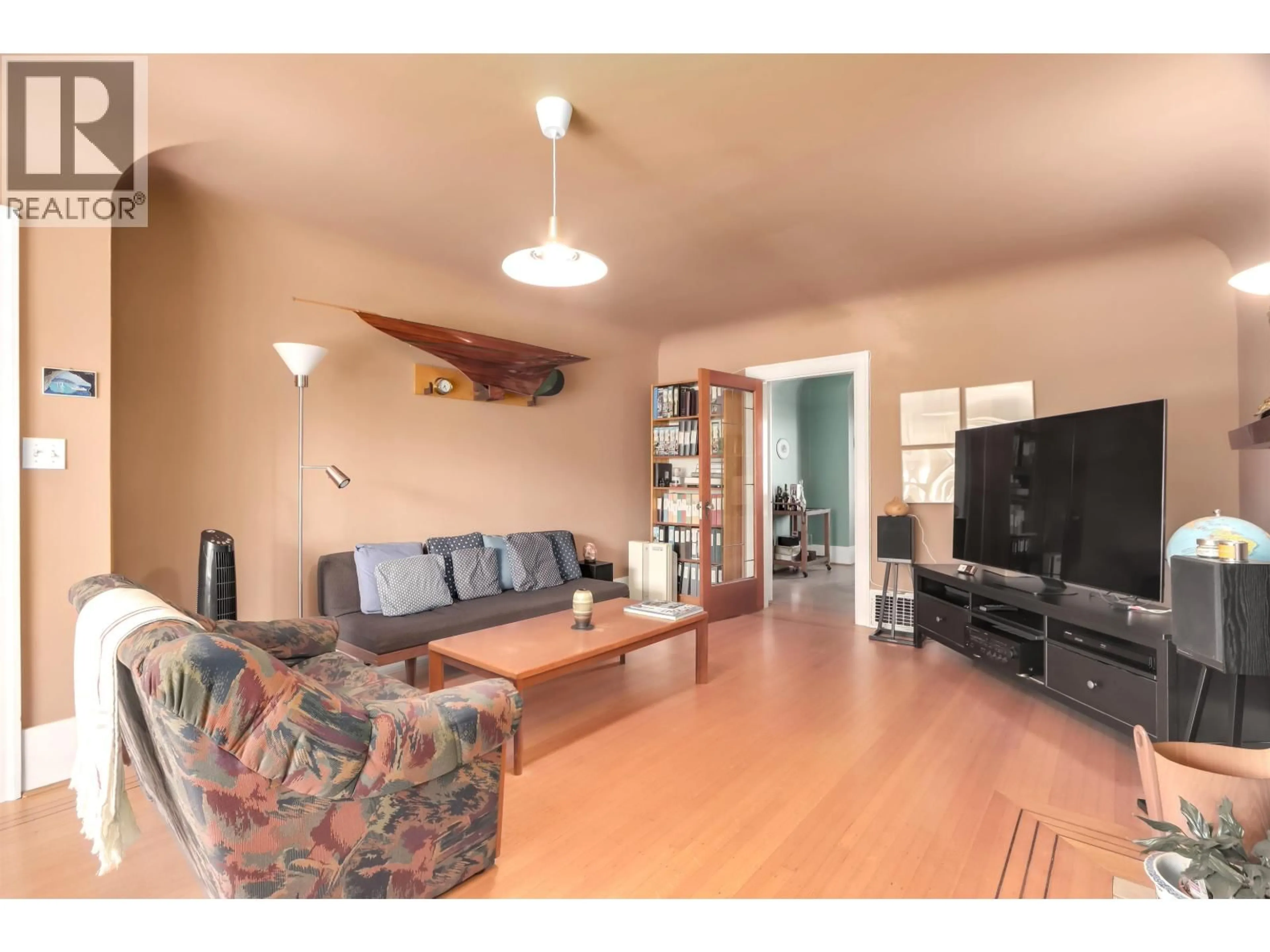 Living room with furniture, wood/laminate floor for 4529 8TH AVENUE, Vancouver British Columbia V6R2A4