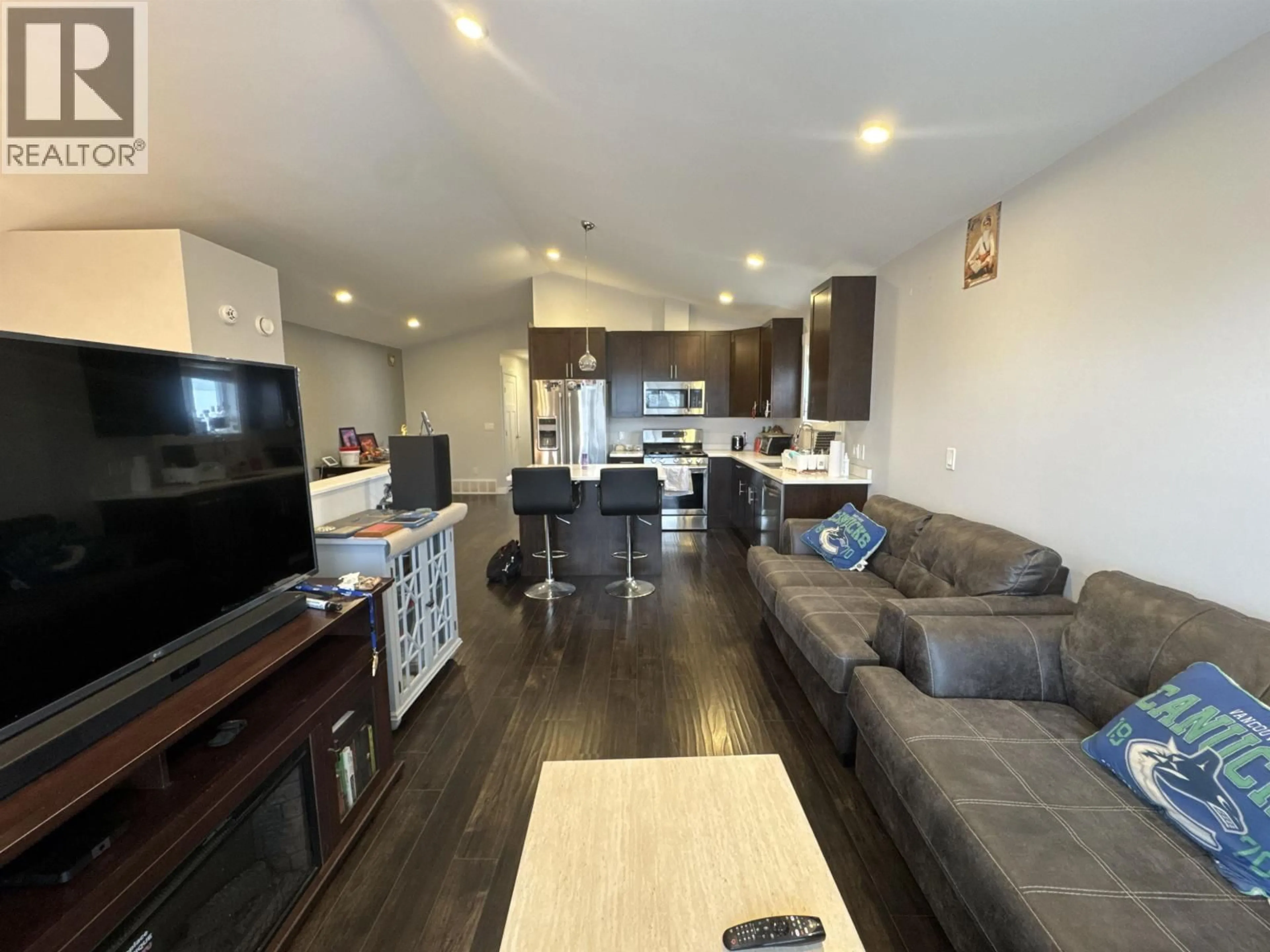 Open concept kitchen, wood/laminate floor for 8707 76 STREET, Fort St. John British Columbia V1J2Z5