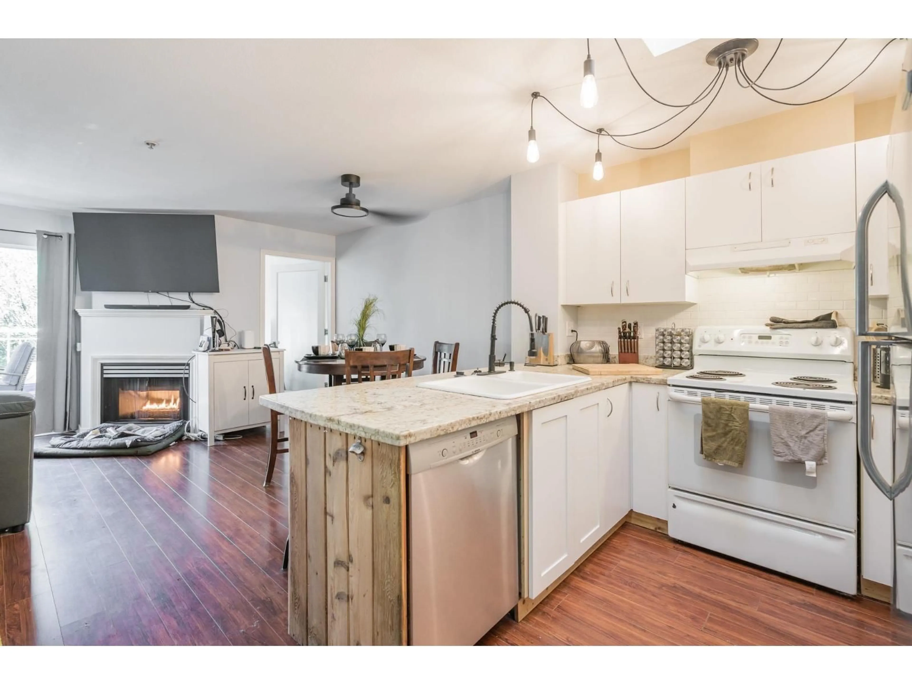 Open concept kitchen, wood/laminate floor for 415 - 6359 198, Langley British Columbia V2Y2E3