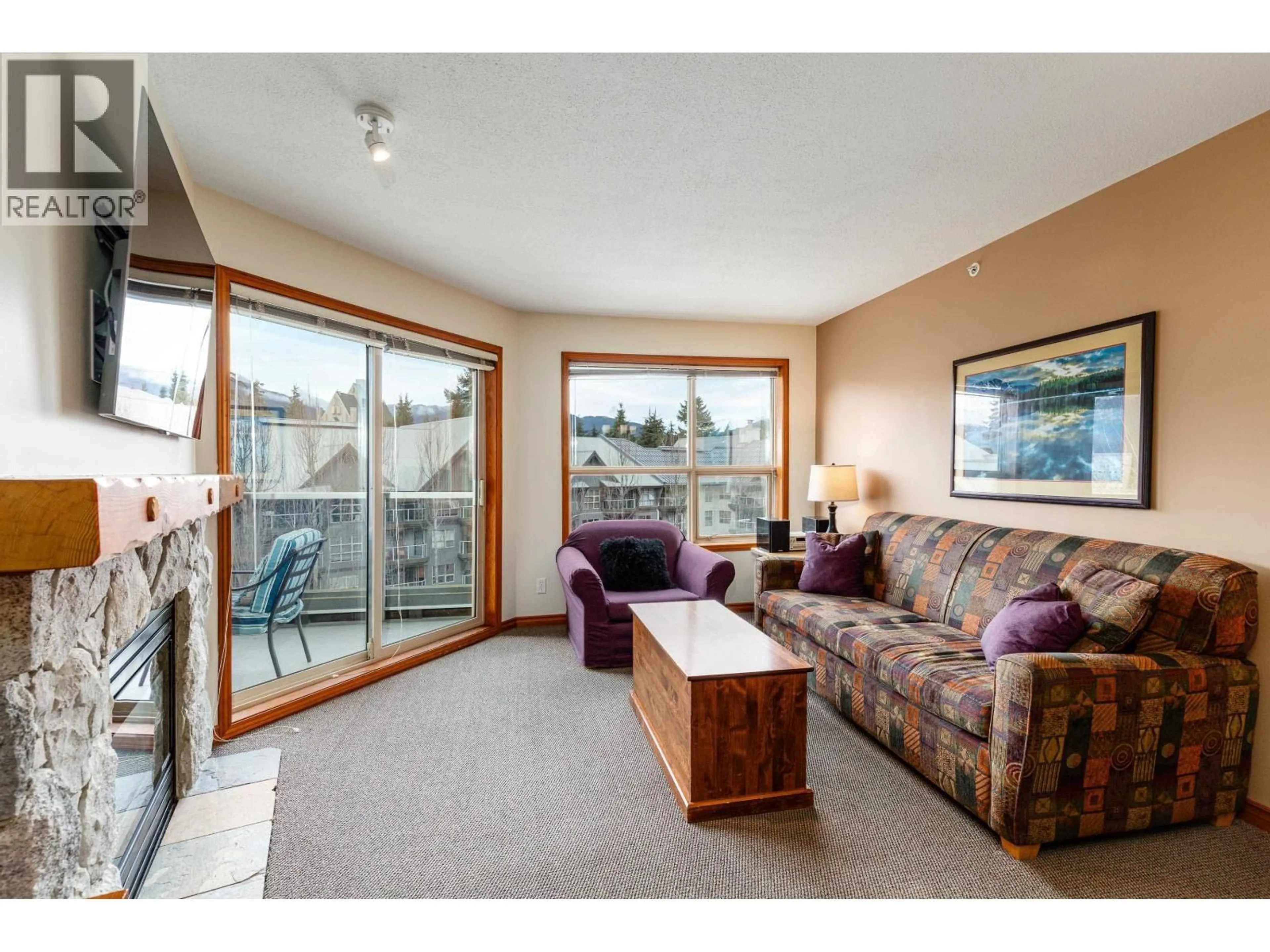 Living room with furniture, wood/laminate floor for 557 - 4800 SPEARHEAD DRIVE, Whistler British Columbia V8E1G1