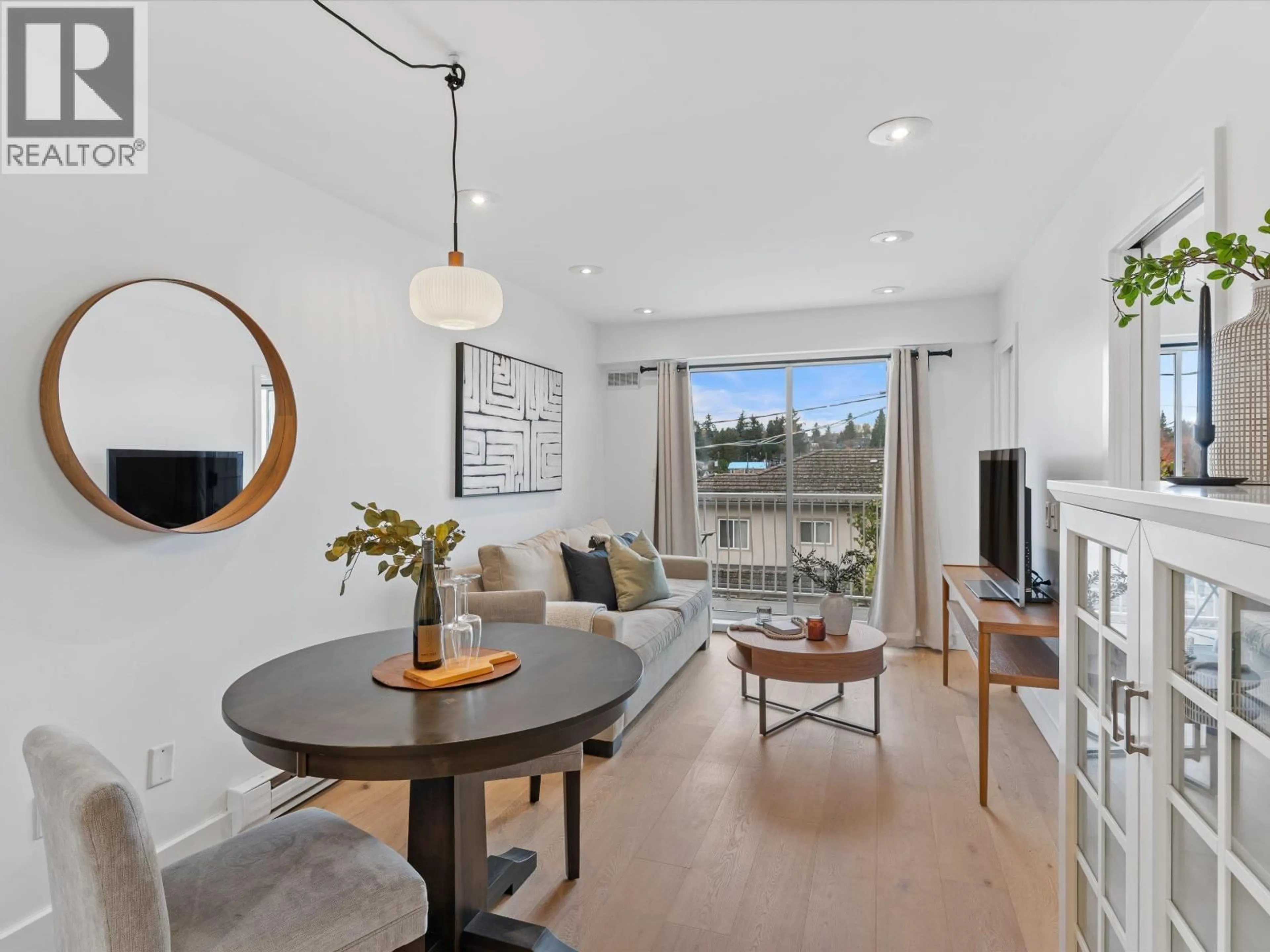 Living room with furniture, wood/laminate floor for 201 - 4315 FRASER STREET, Vancouver British Columbia V5V4G4