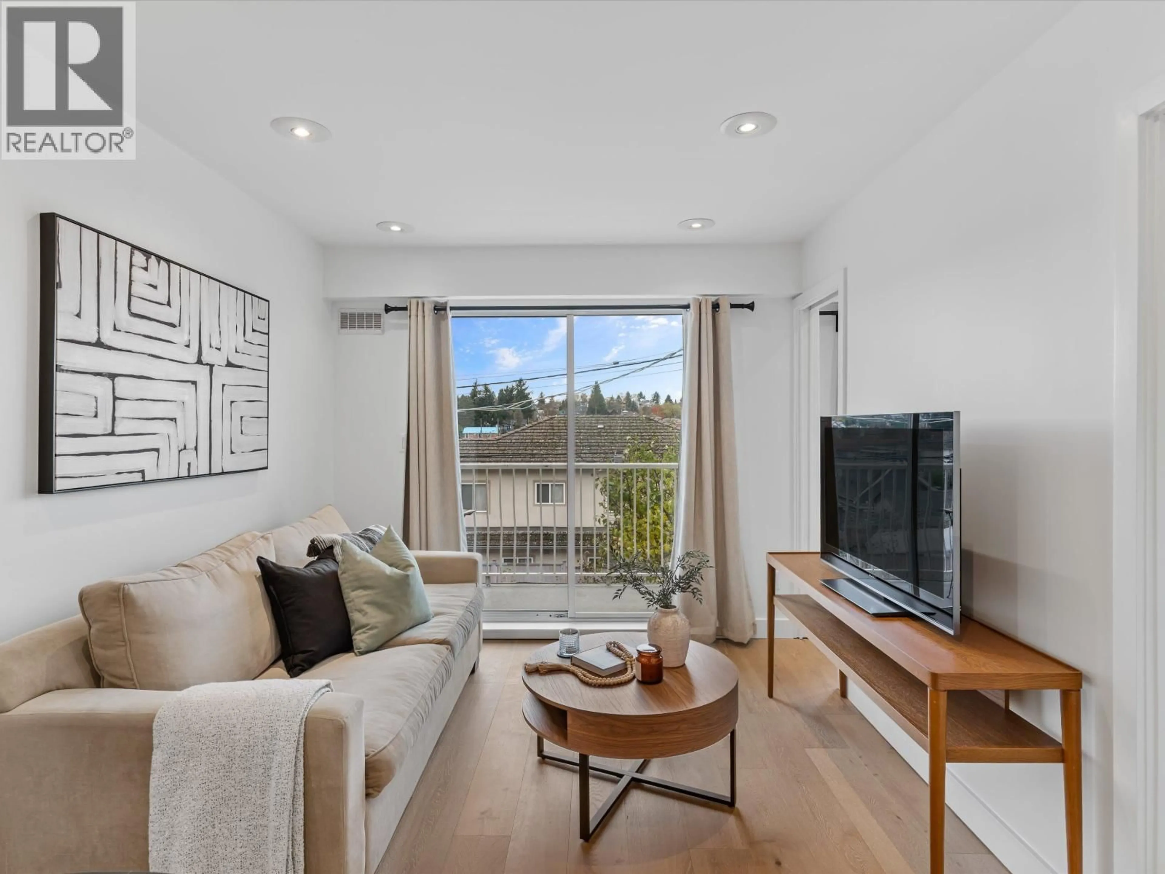 Living room with furniture, wood/laminate floor for 201 - 4315 FRASER STREET, Vancouver British Columbia V5V4G4