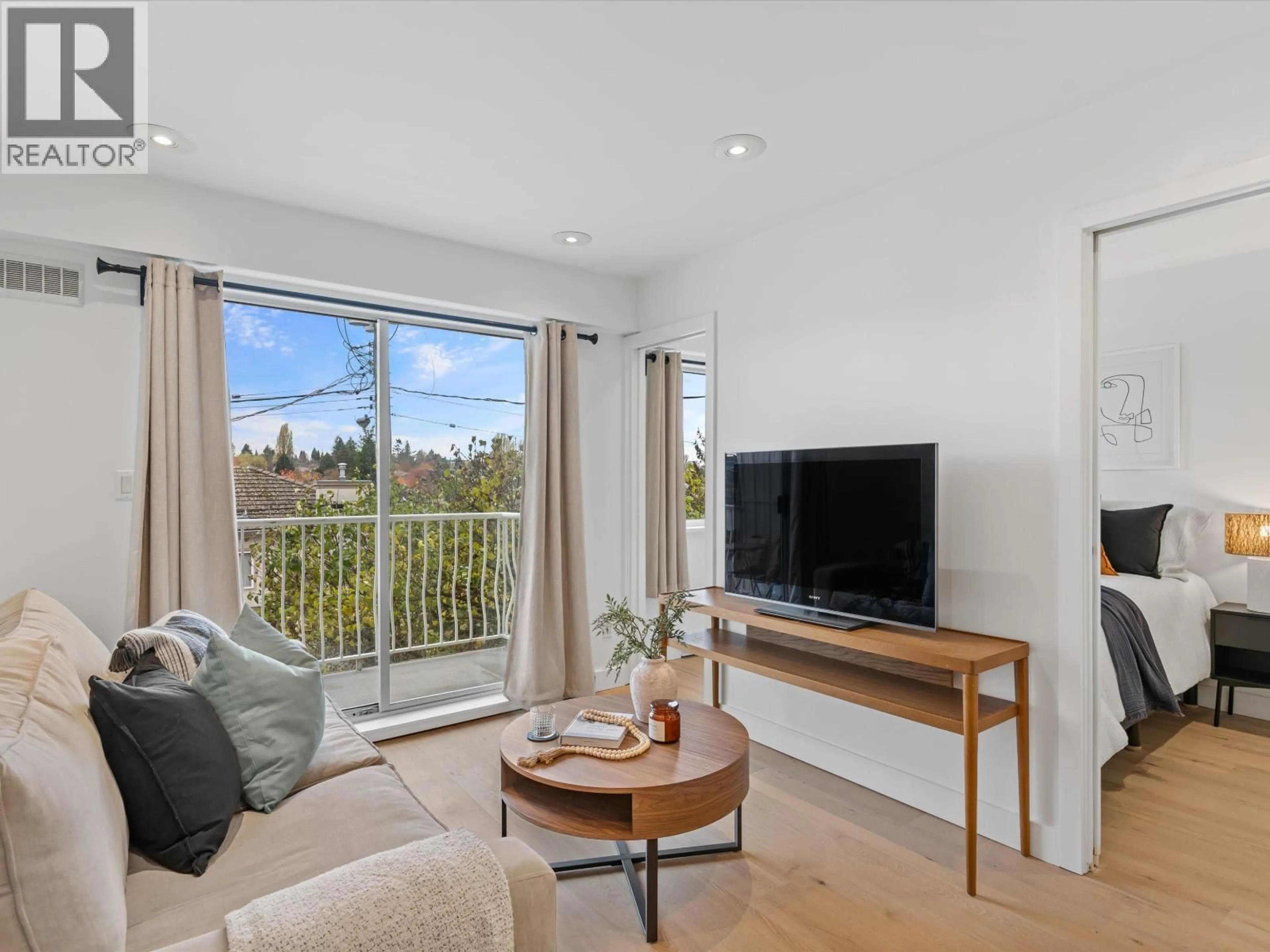 Living room with furniture, wood/laminate floor for 201 - 4315 FRASER STREET, Vancouver British Columbia V5V4G4