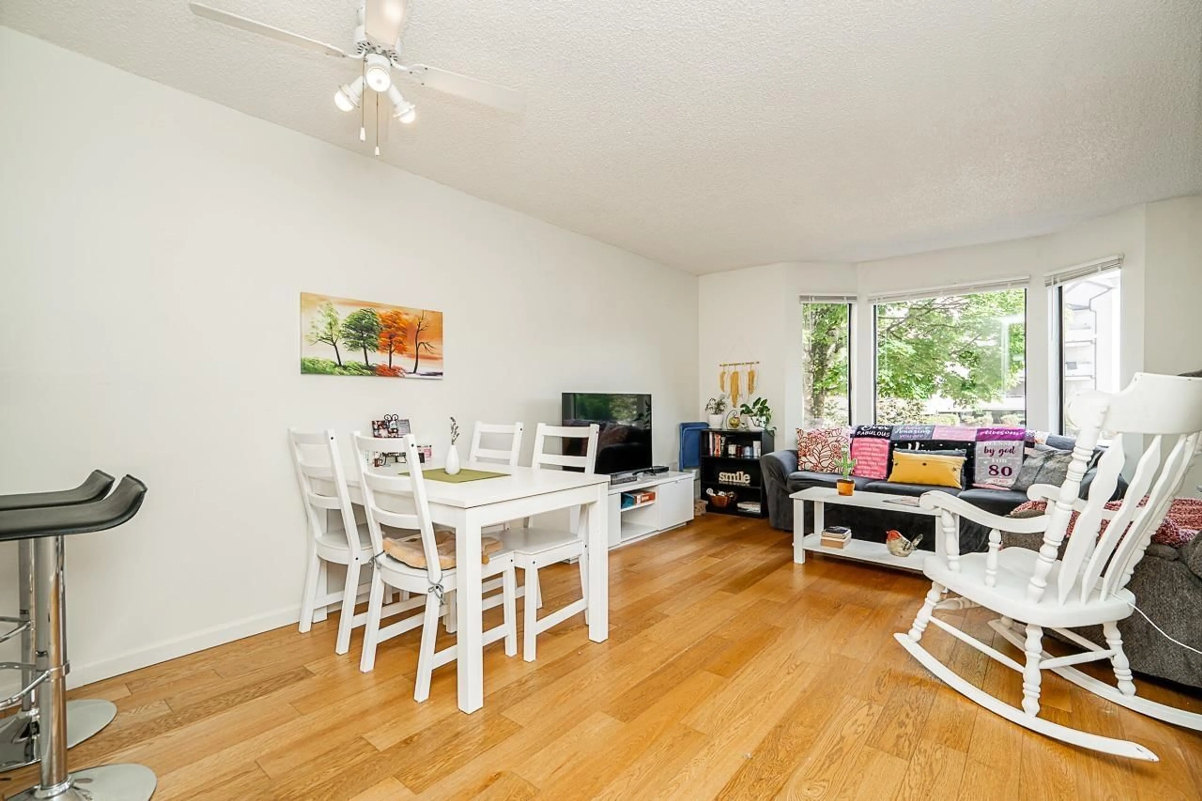 Living room with furniture, wood/laminate floor for 106 - 5224 204, Langley British Columbia V3A1Z1