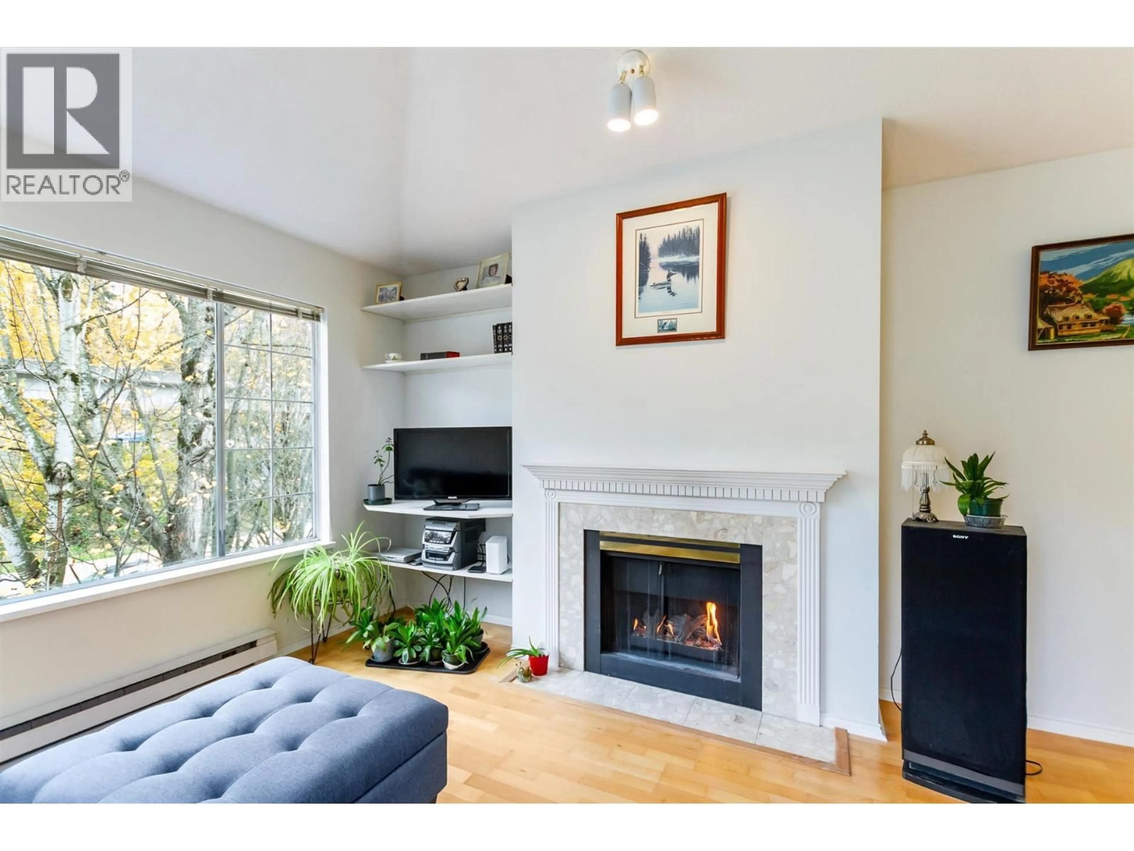 Living room with furniture, wood/laminate floor for 406 - 6820 RUMBLE STREET, Burnaby British Columbia V5E4H9