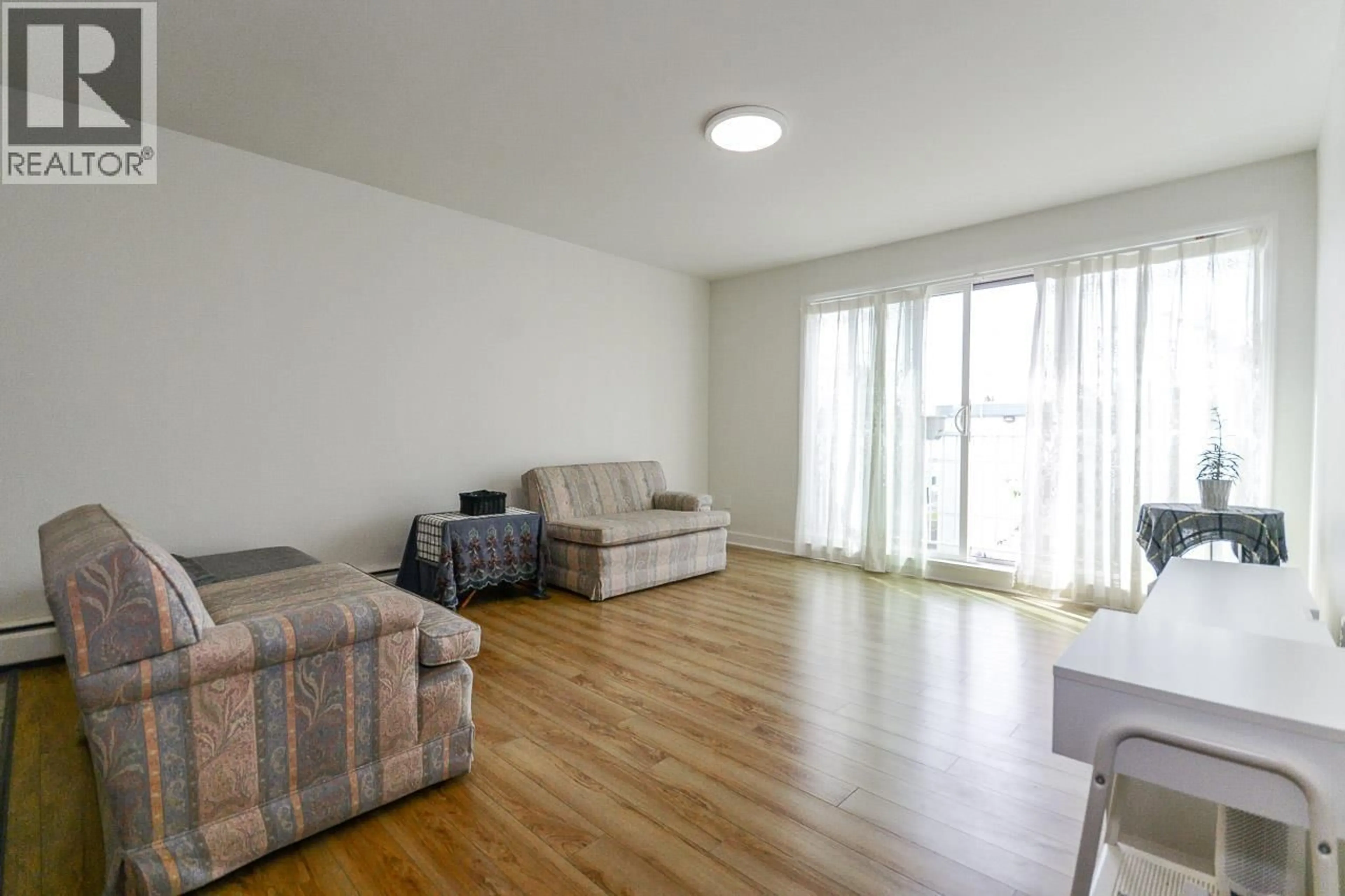 Living room with furniture, wood/laminate floor for 301 - 7200 LINDSAY ROAD, Richmond British Columbia V7C3M6