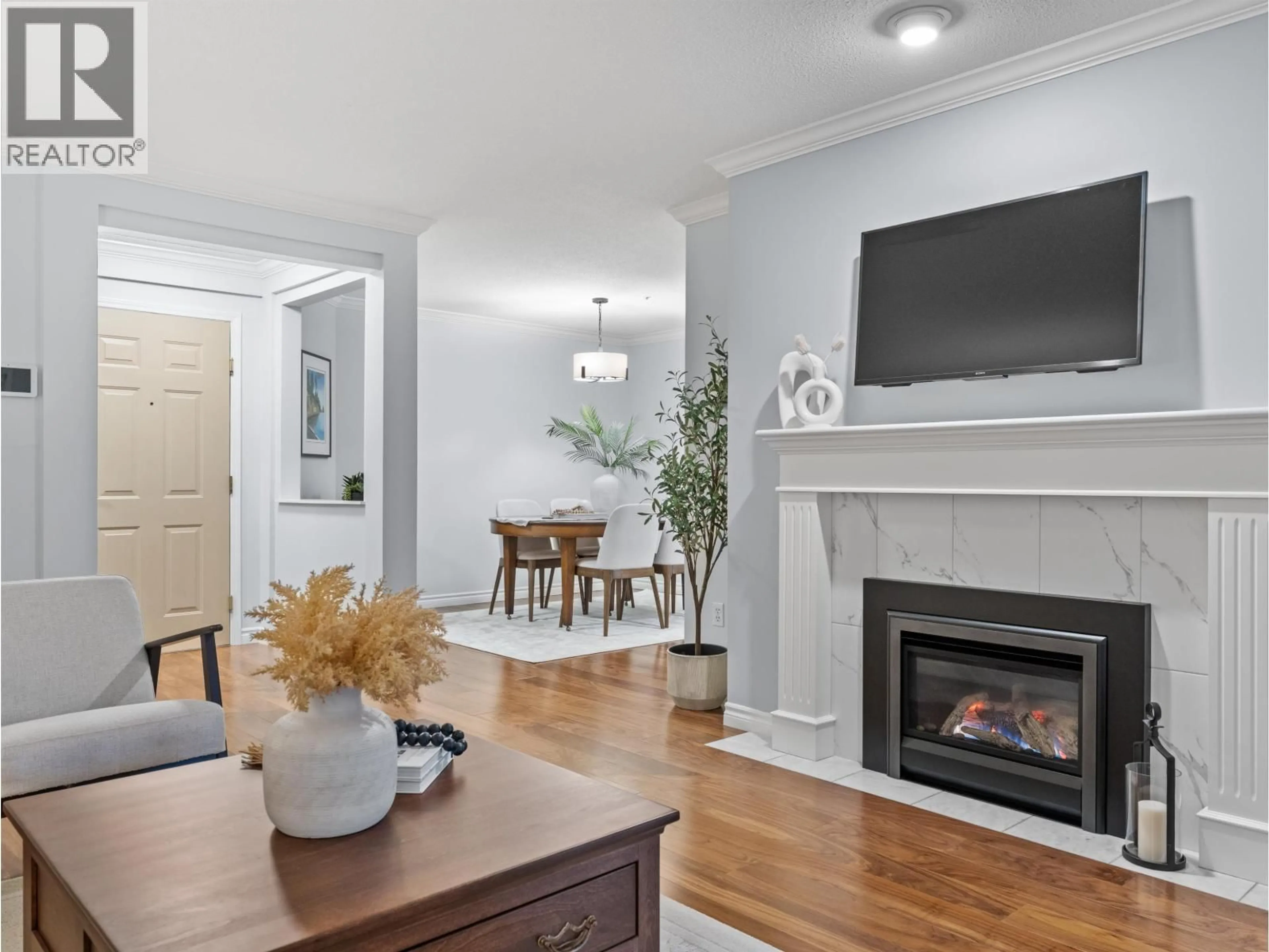 Living room with furniture, wood/laminate floor for 107 - 3690 BANFF COURT, North Vancouver British Columbia V7H2Y7