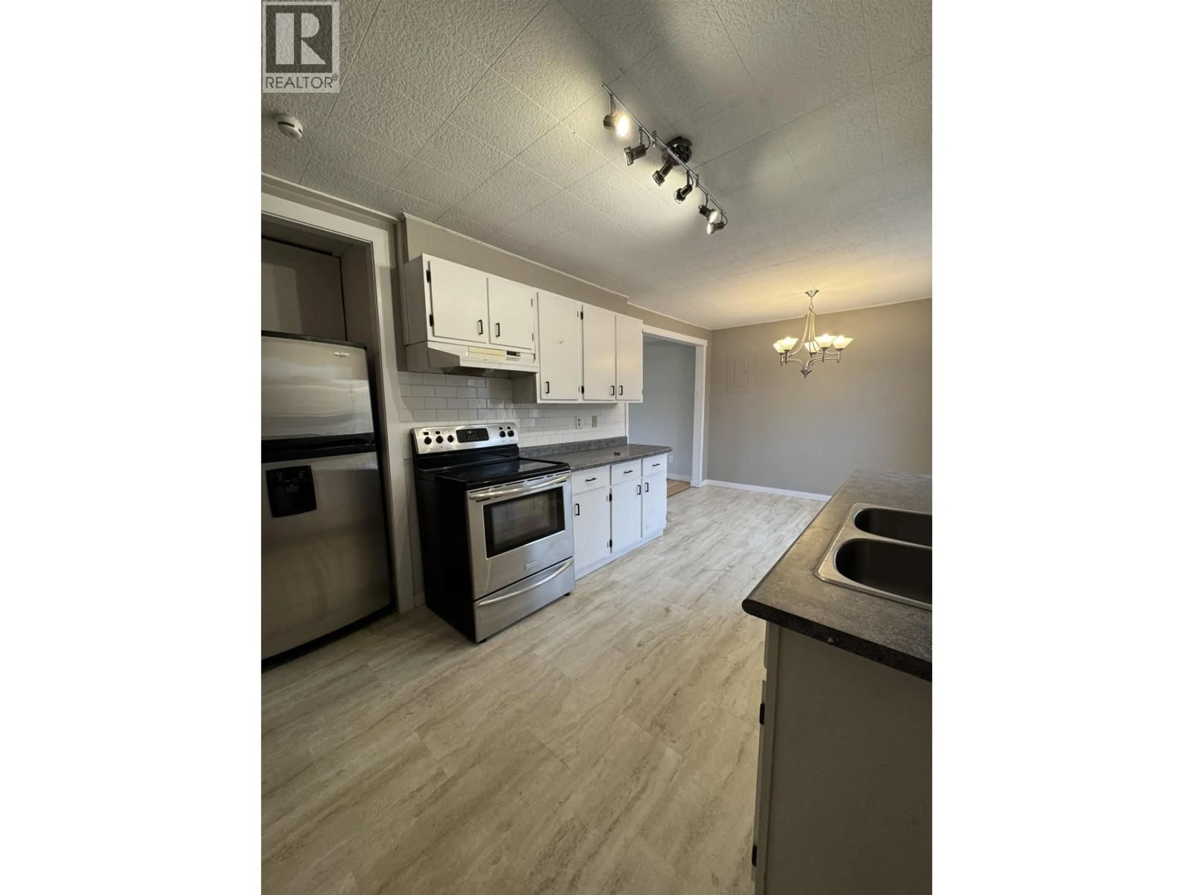 Open concept kitchen, wood/laminate floor for 657 PINCHBECK STREET, Williams Lake British Columbia V2G1E6