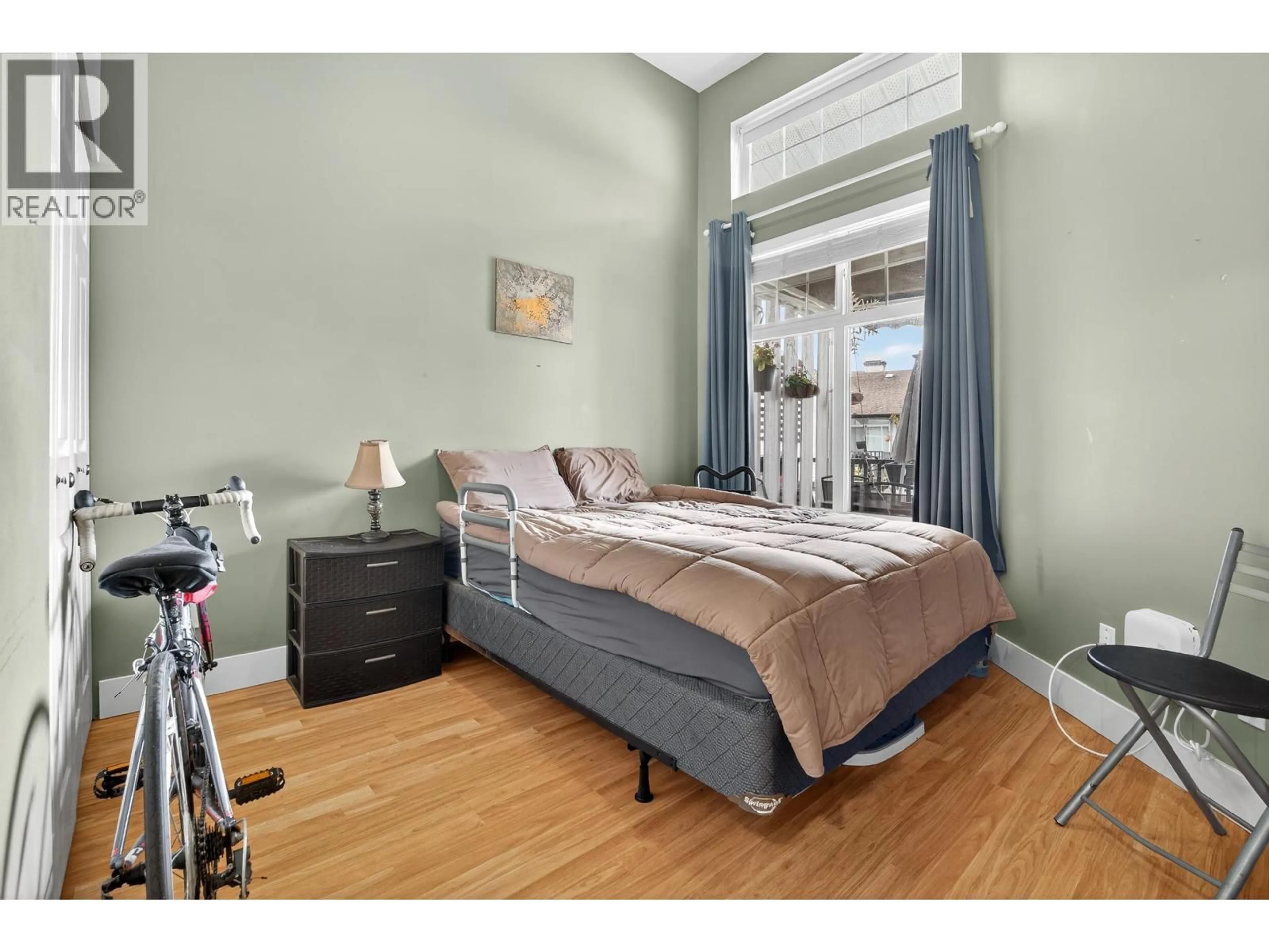 Bedroom with bed, wood/laminate floor for 416 - 83 STAR CRESCENT, New Westminster British Columbia V3M6X8