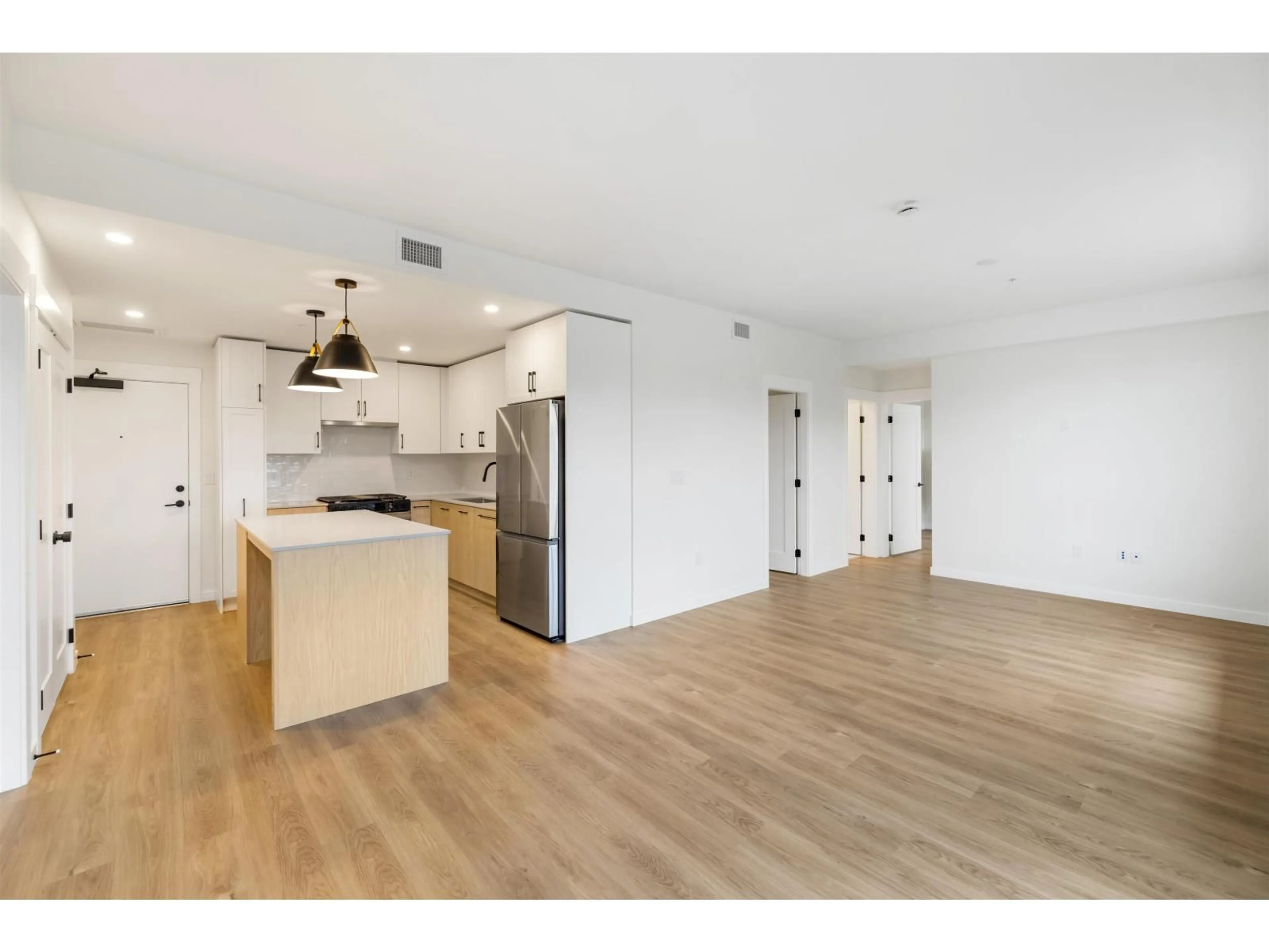 Open concept kitchen, wood/laminate floor for 601 - 27218 ALDERGROVE TOWN CENTRE, Langley British Columbia V4W0E4