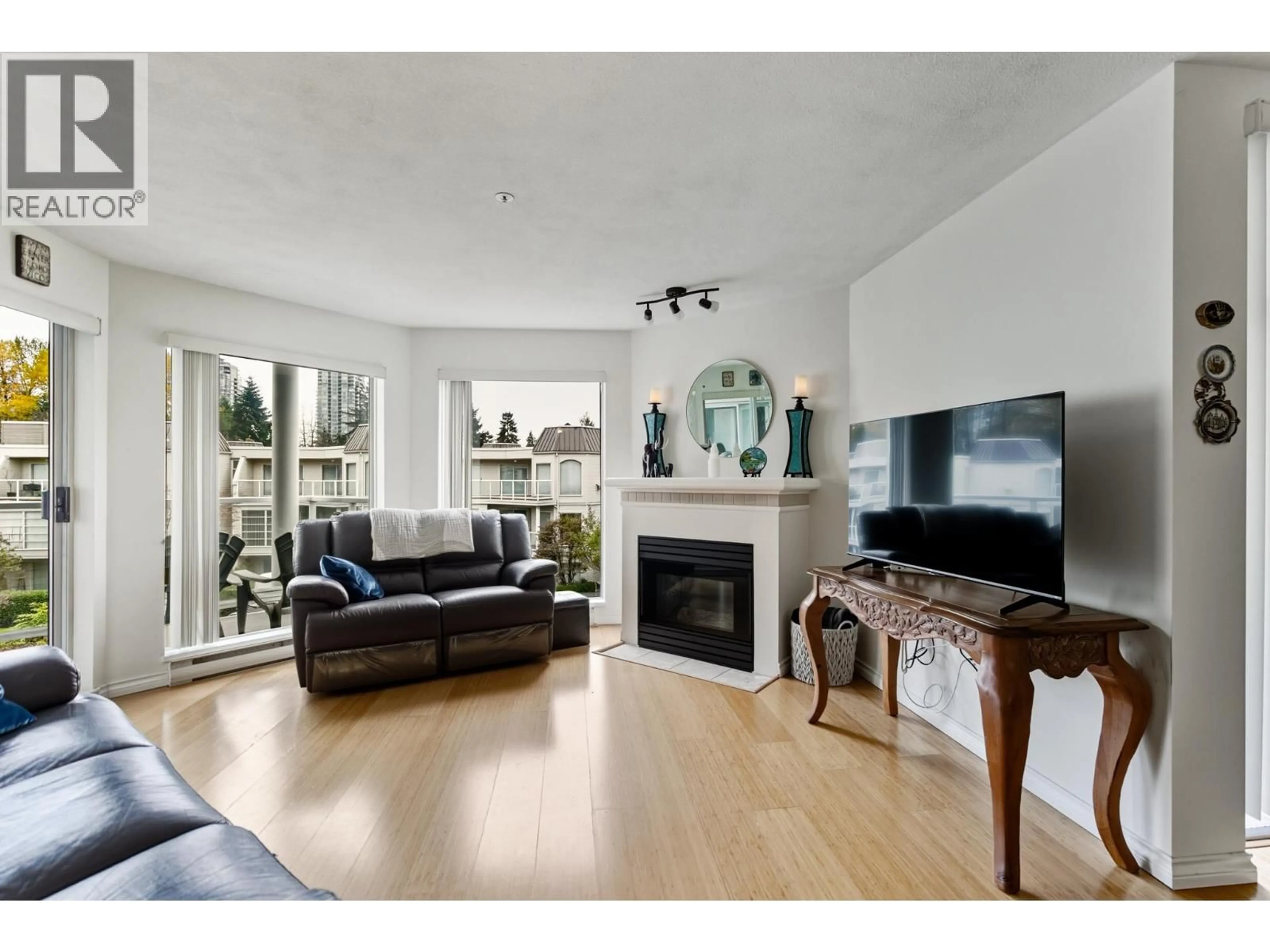 Living room with furniture, wood/laminate floor for 320 - 1220 LASALLE PLACE, Coquitlam British Columbia V3B7L6