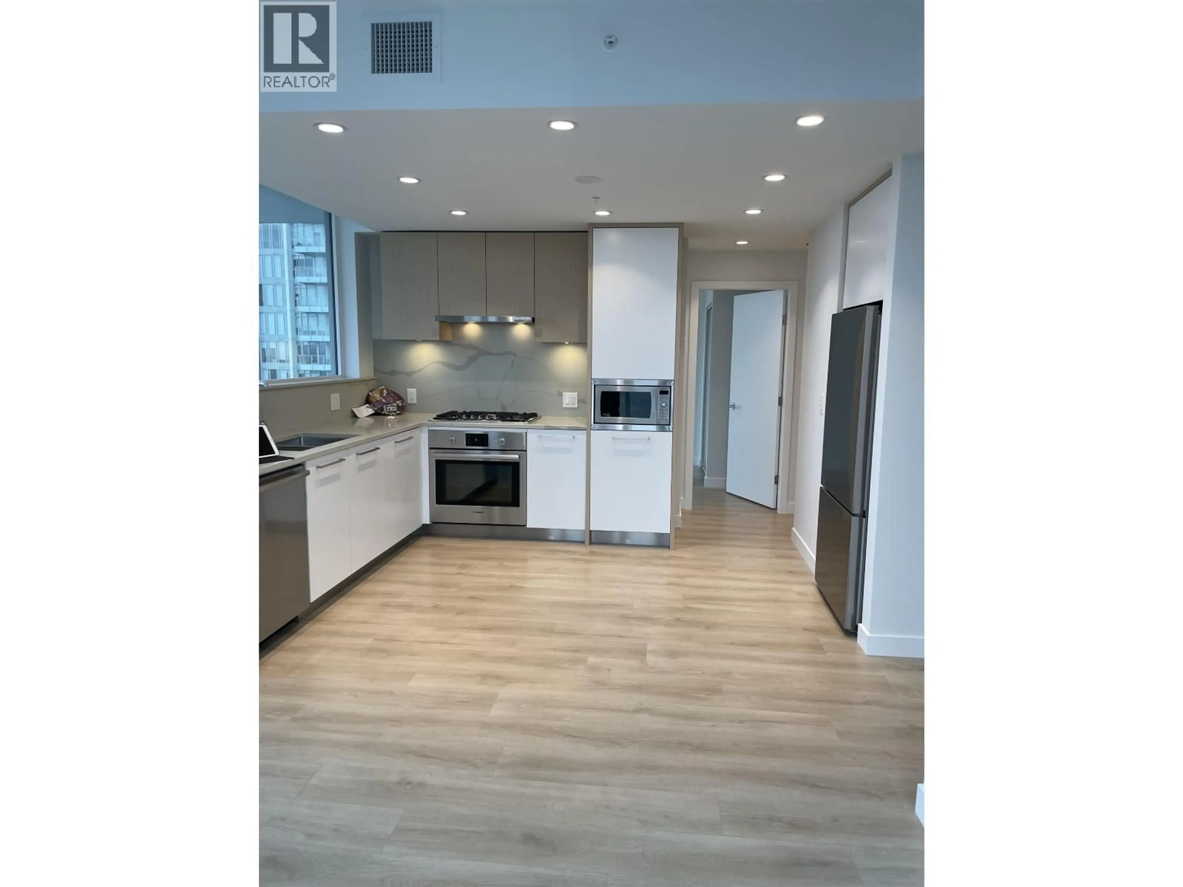 Open concept kitchen, wood/laminate floor for 1609 - 567 CLARKE ROAD, Coquitlam British Columbia V3J0K7
