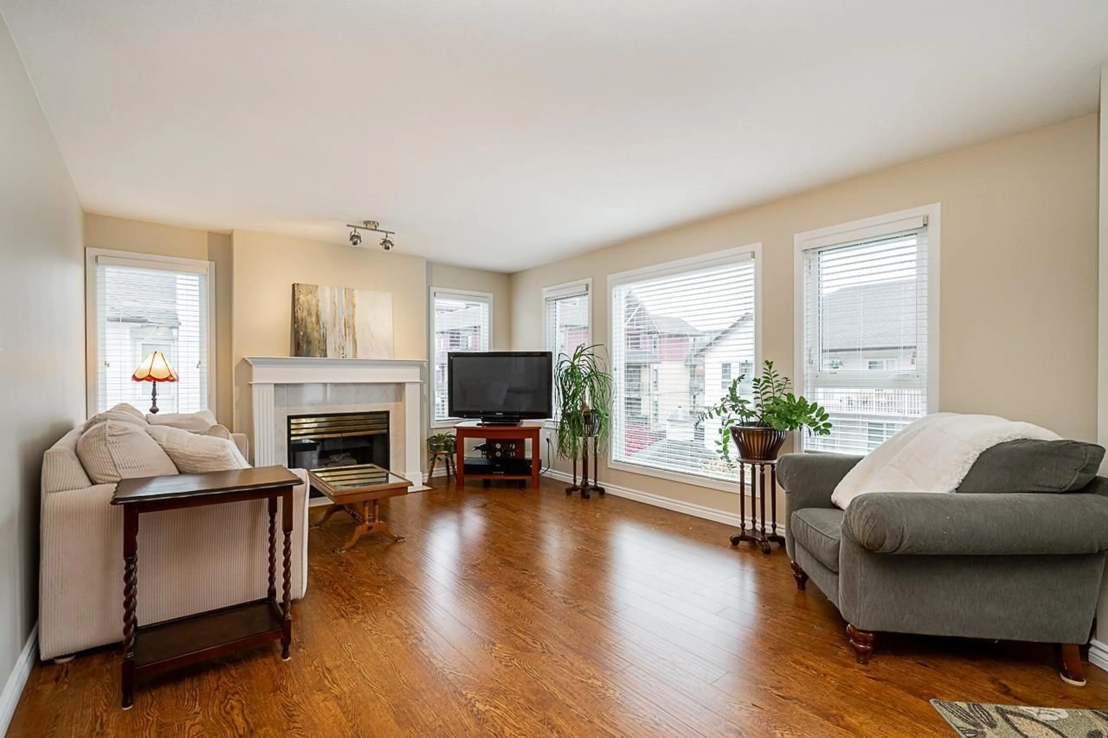 Living room with furniture, wood/laminate floor for 302 - 17730 58A, Surrey British Columbia V3S8M5