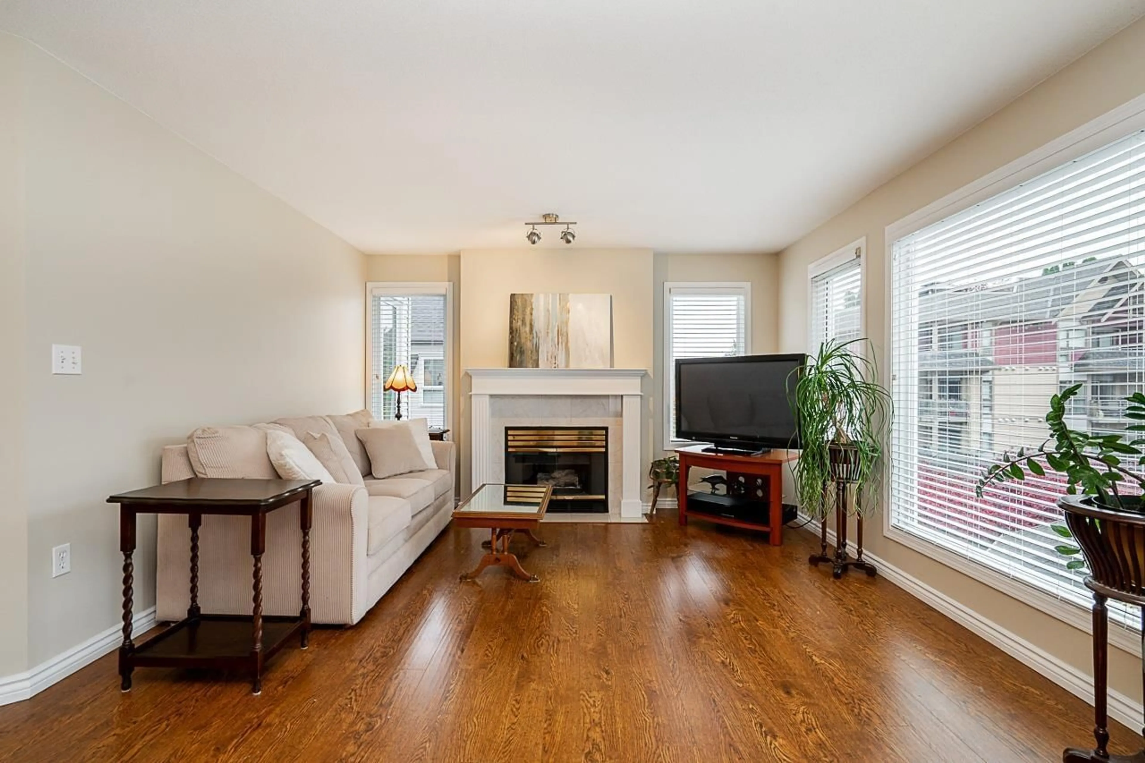 Living room with furniture, wood/laminate floor for 302 - 17730 58A, Surrey British Columbia V3S8M5