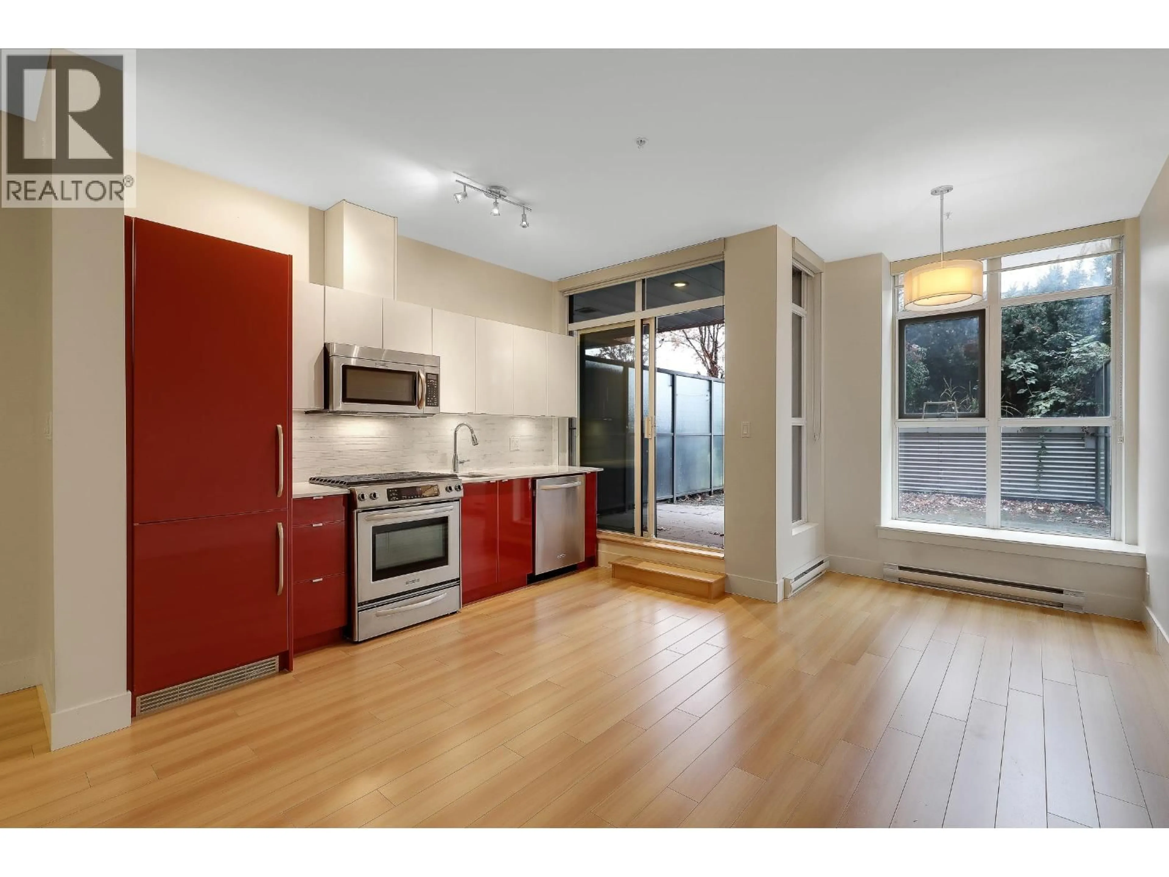 Open concept kitchen, wood/laminate floor for 211 - 2250 COMMERCIAL DRIVE, Vancouver British Columbia V5N5P9