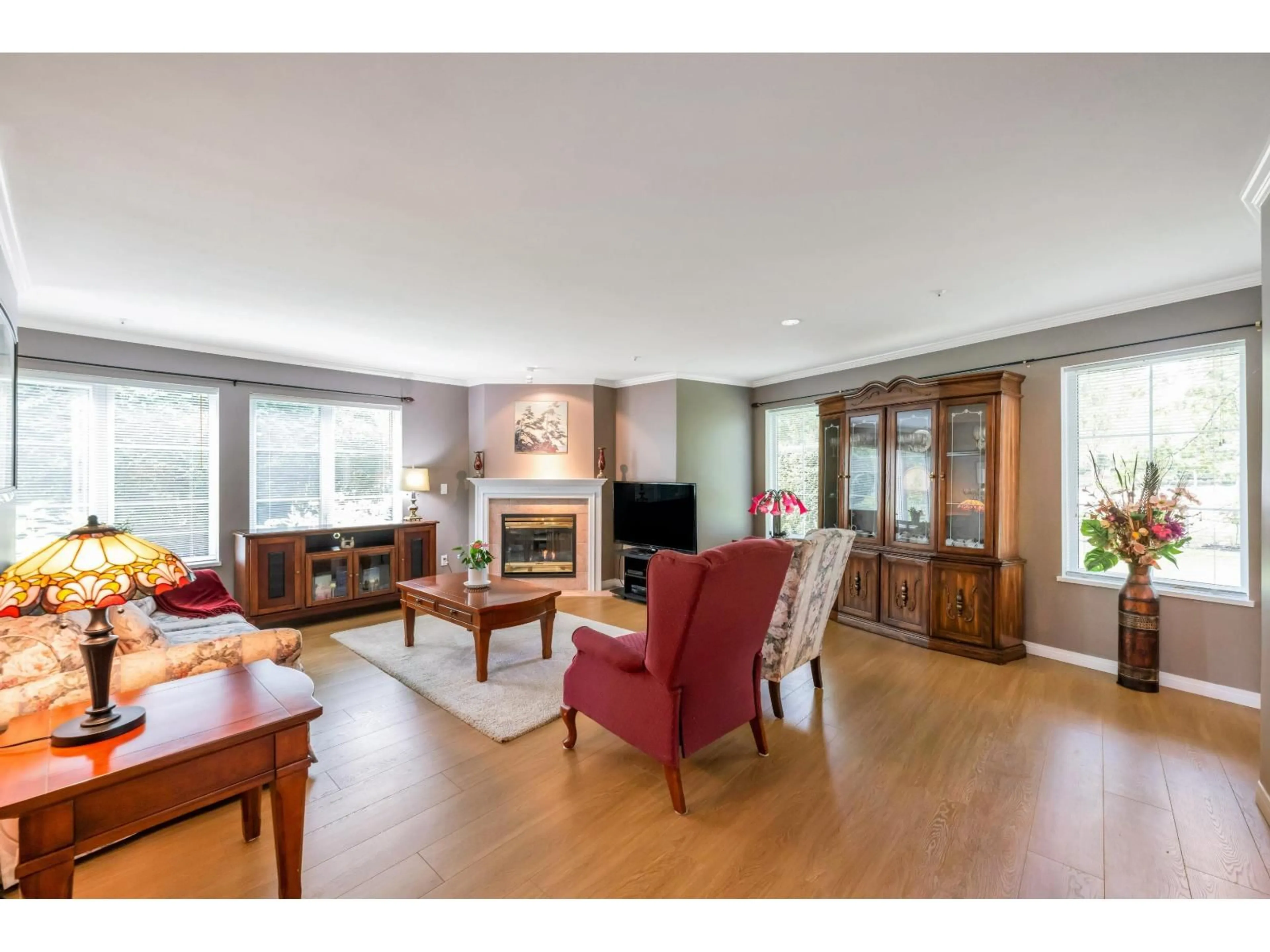 Living room with furniture, wood/laminate floor for 104 - 12155 75A AVENUE, Surrey British Columbia V3W1B9