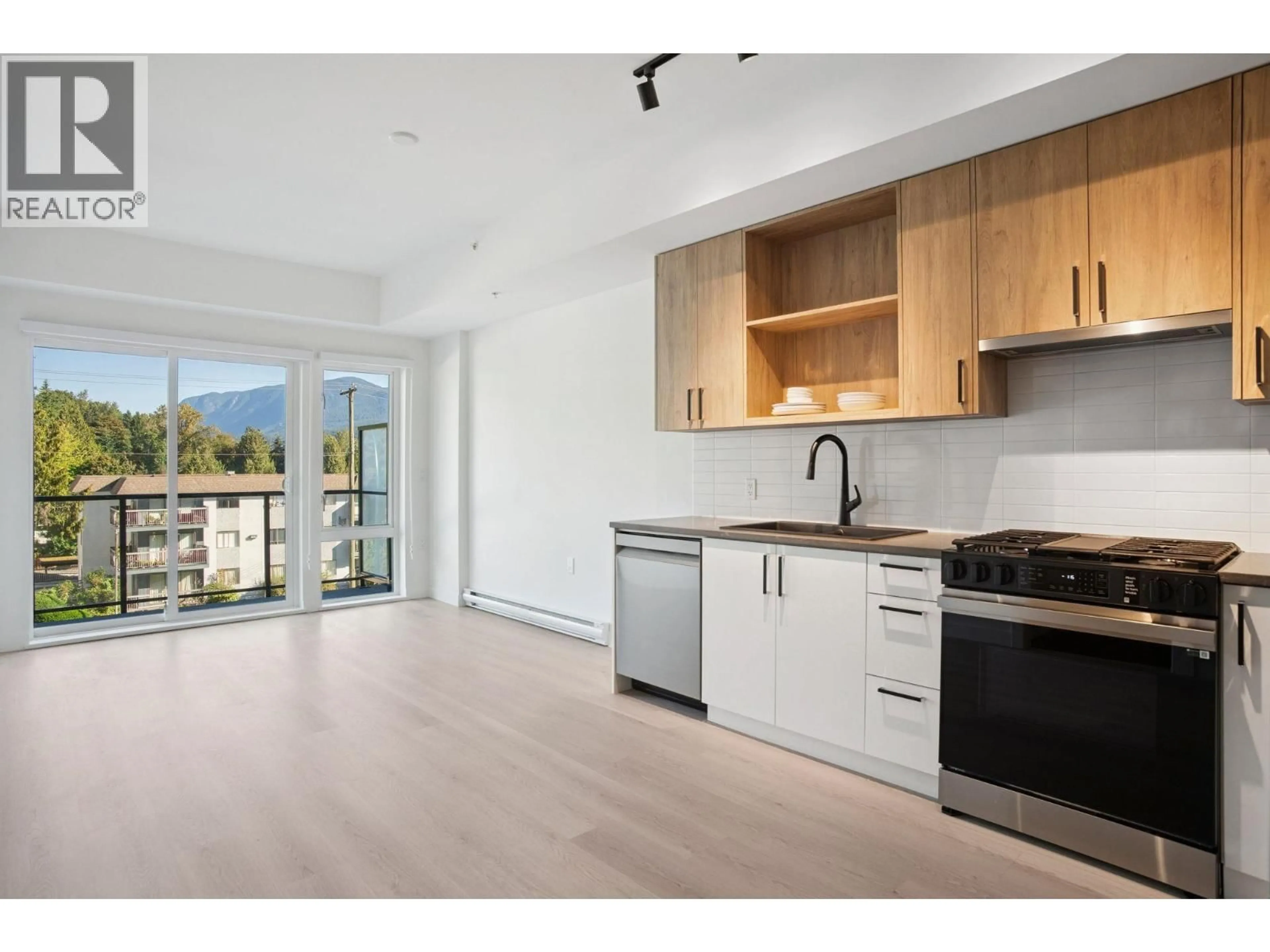 Open concept kitchen, wood/laminate floor for 105 - 1100 CLARKE ROAD, Port Moody British Columbia V6M4B9