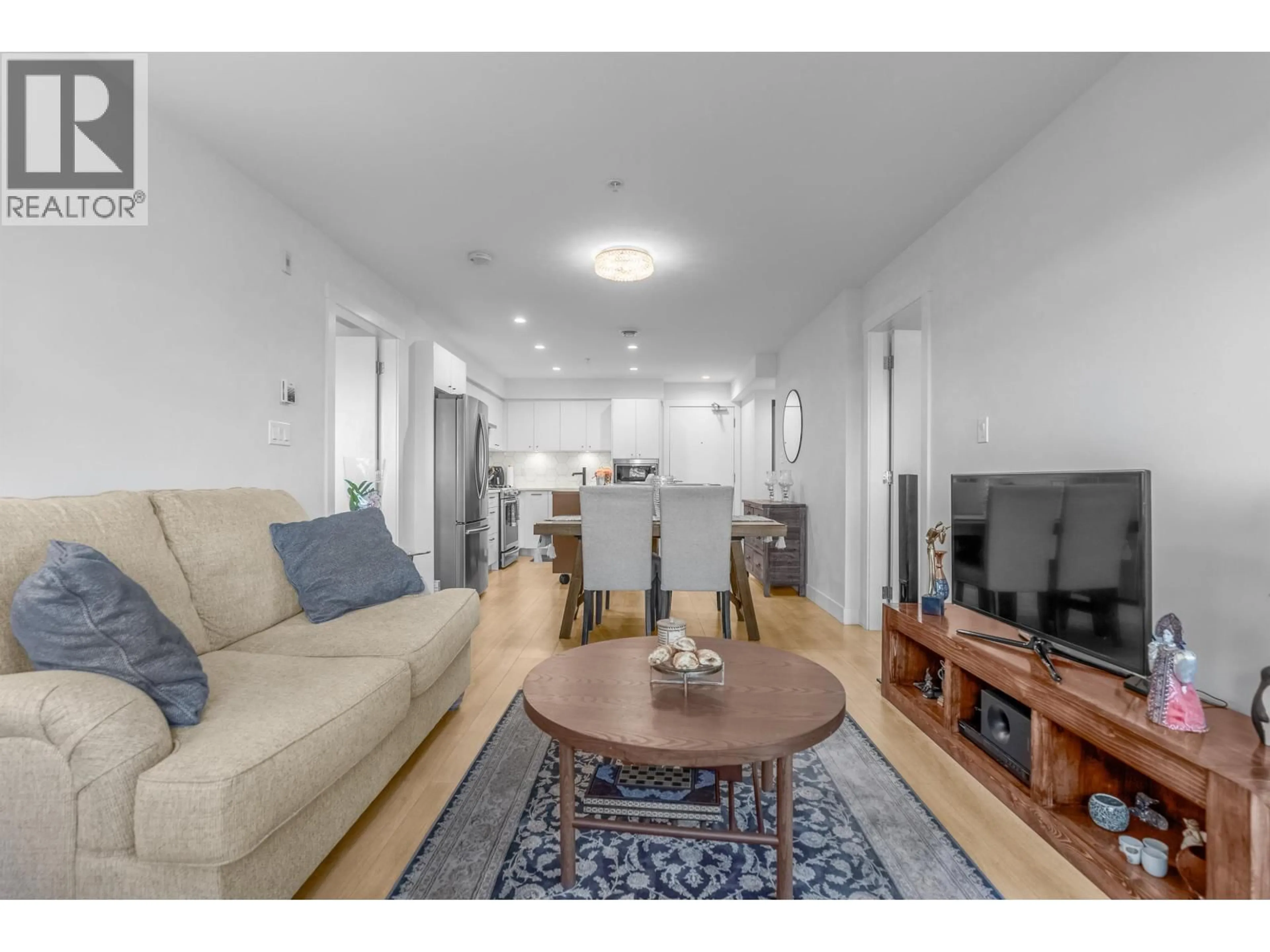 Living room with furniture, wood/laminate floor for 406 - 1519 CROWN STREET, North Vancouver British Columbia V7J1G6