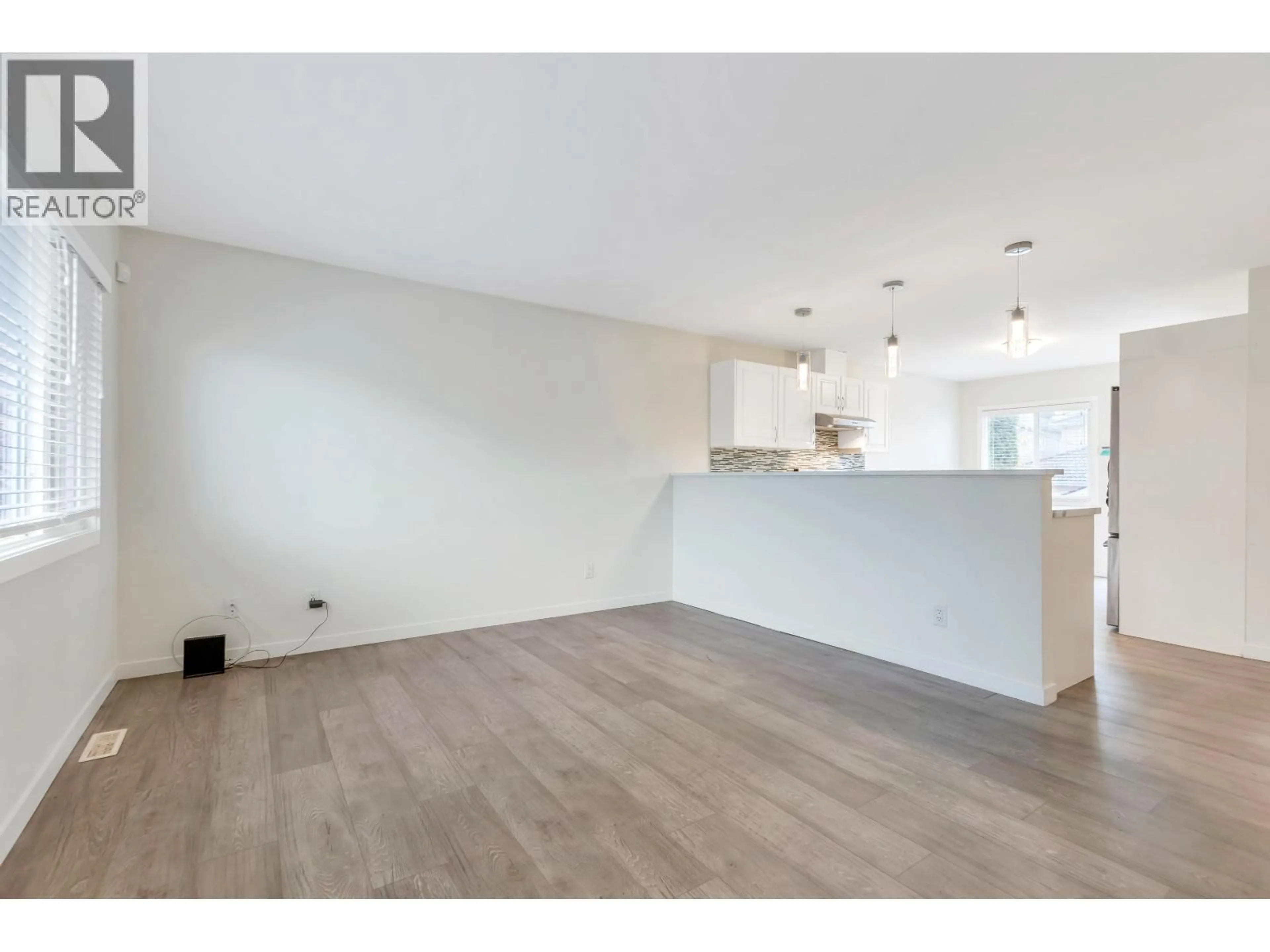 Open concept kitchen, wood/laminate floor for 2052 41ST AVENUE, Vancouver British Columbia V5P1L4