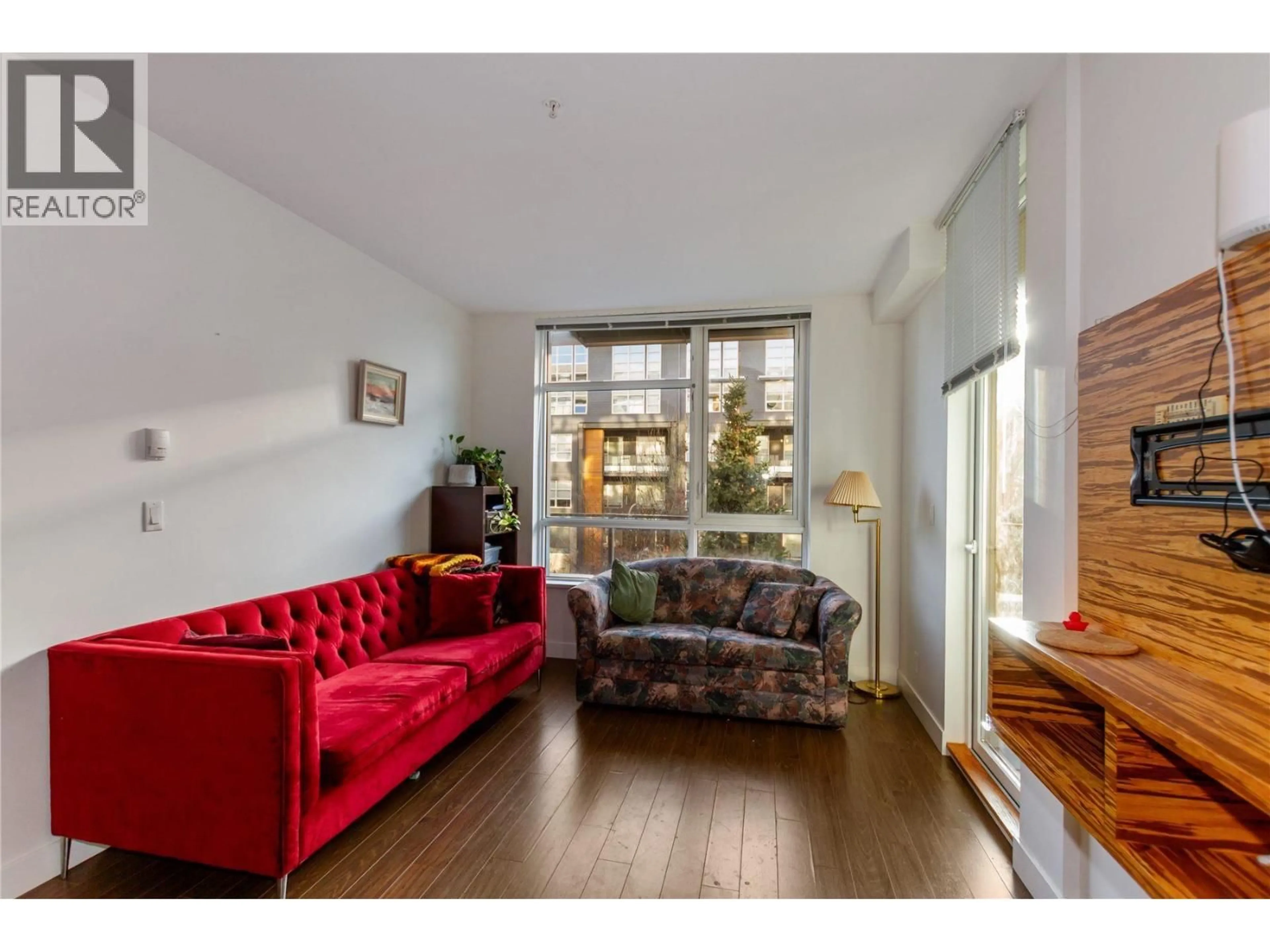 Living room with furniture, wood/laminate floor for 101 - 9150 UNIVERSITY HIGH STREET, Burnaby British Columbia V5A0C5