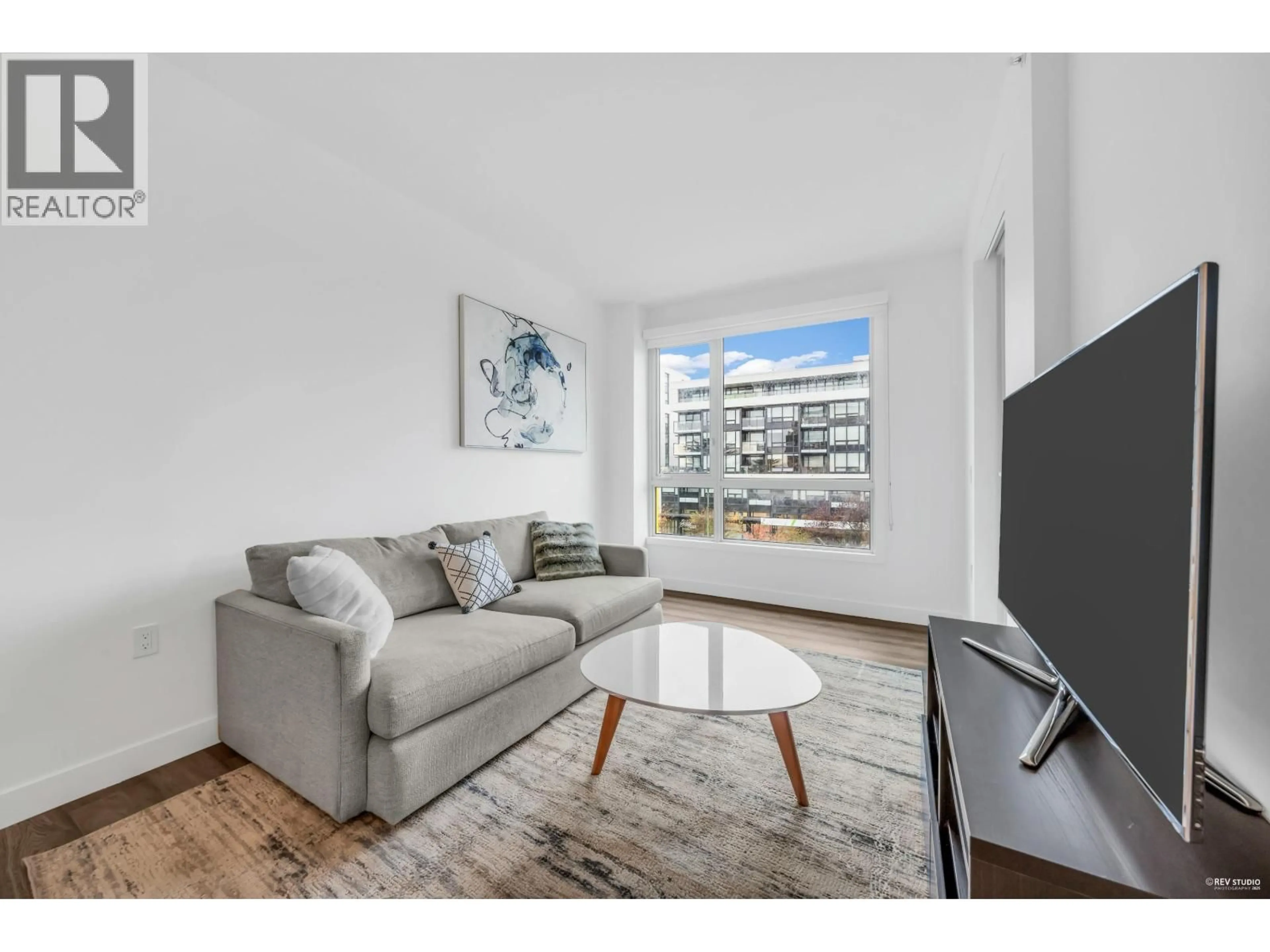 Living room with furniture, wood/laminate floor for 407 - 6328 CAMBIE STREET, Vancouver British Columbia V5Z0K2