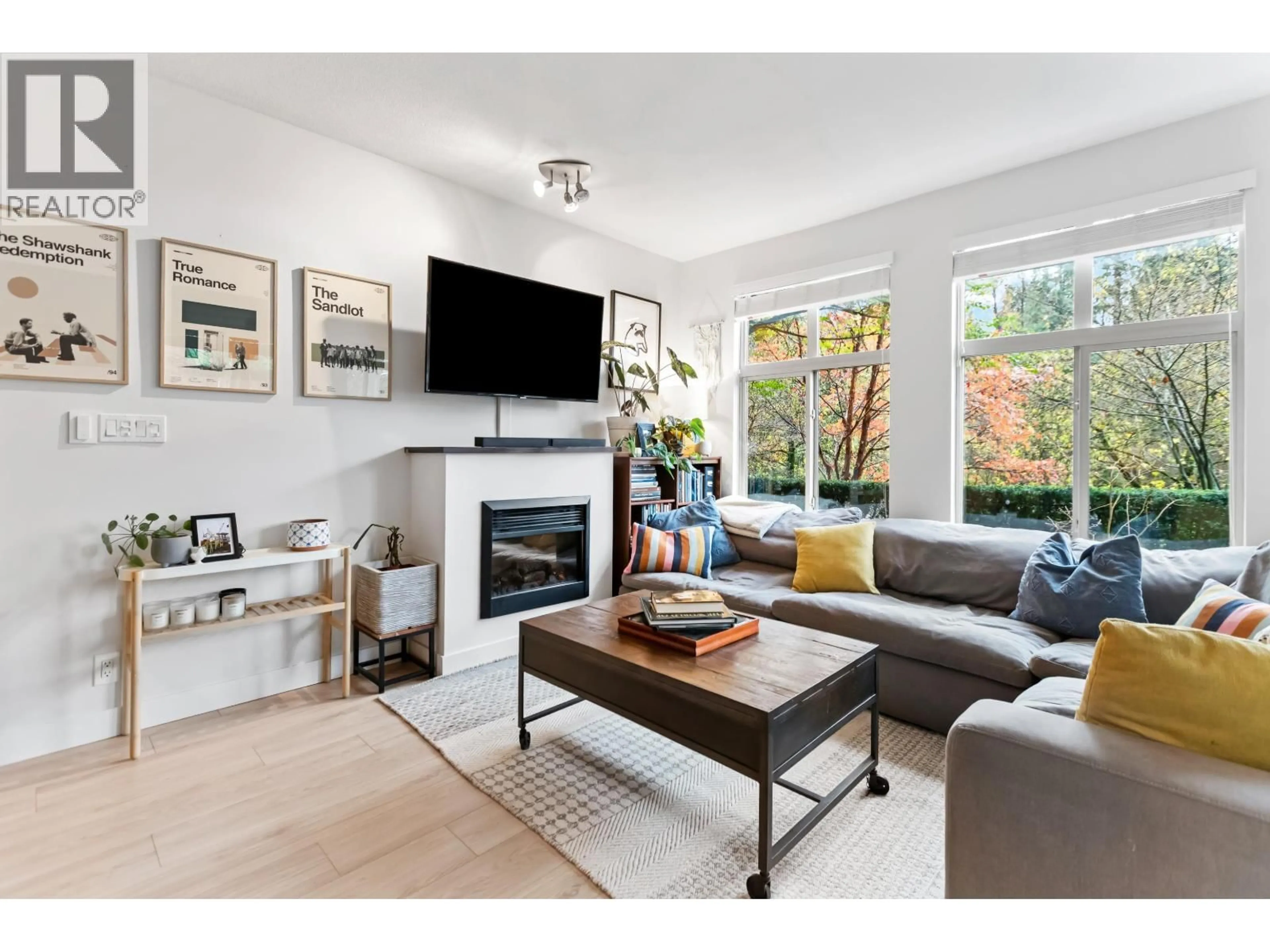 Living room with furniture, wood/laminate floor for 112 - 101 MORRISSEY ROAD, Port Moody British Columbia V3H0E6