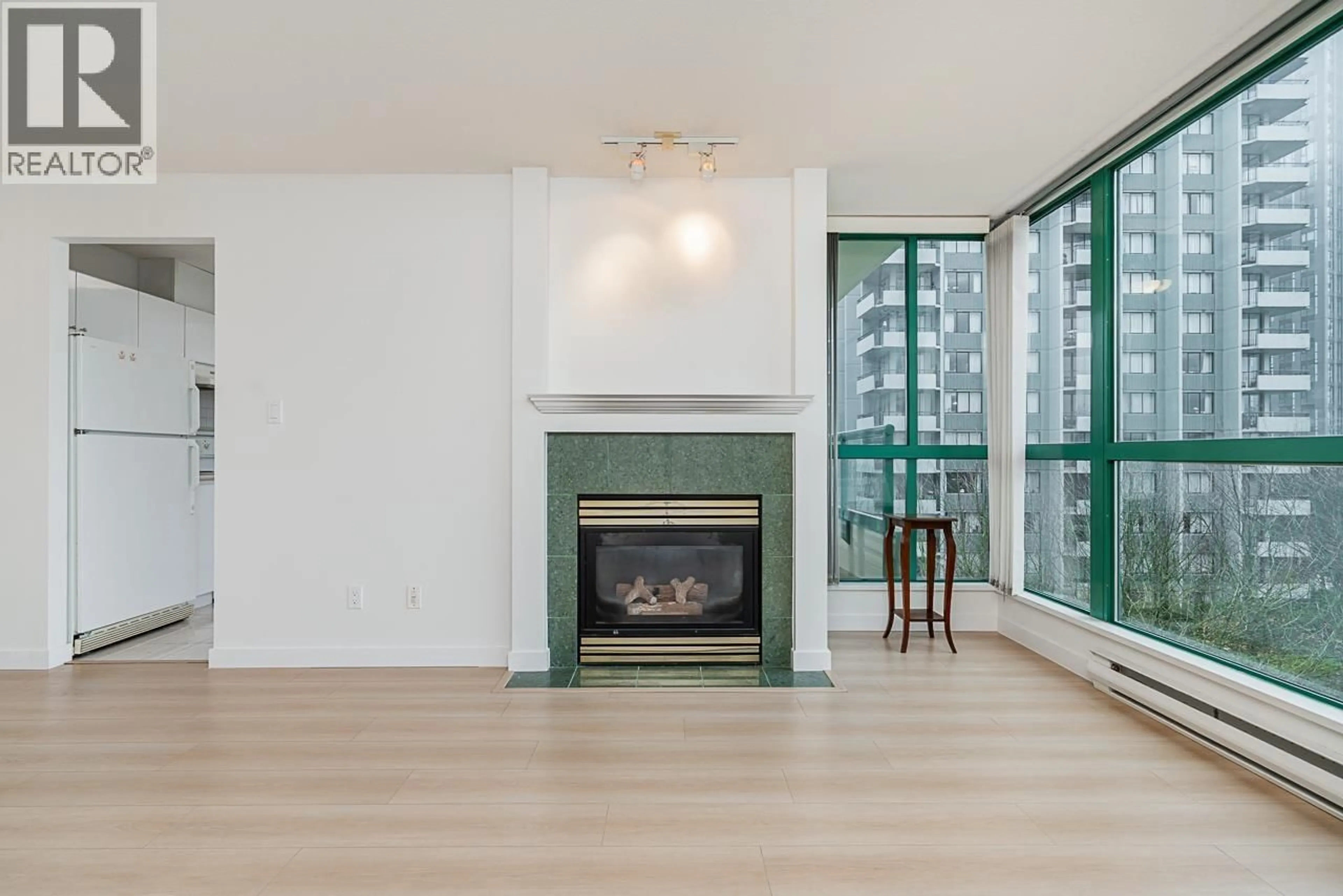 Living room with furniture, wood/laminate floor for 607 - 5899 WILSON AVENUE, Burnaby British Columbia V5H4R9