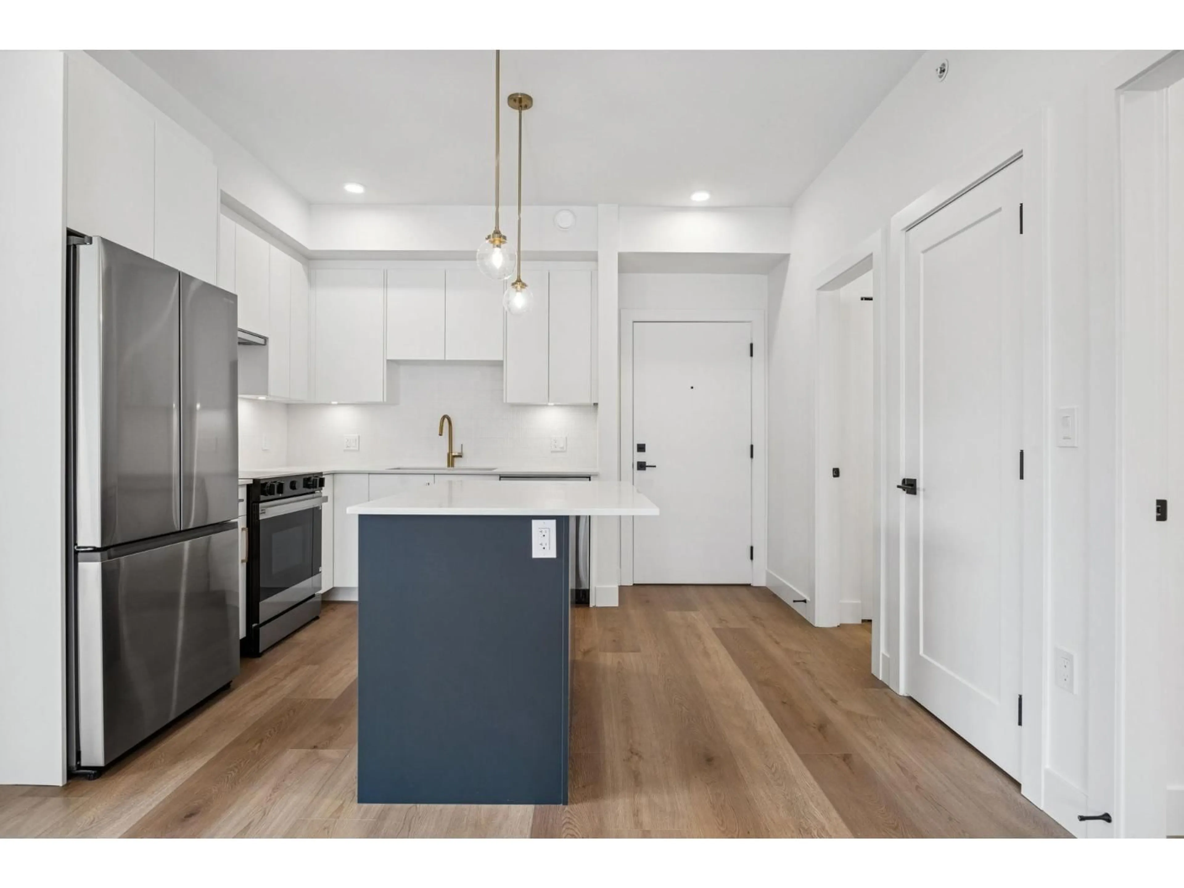 Open concept kitchen, wood/laminate floor for 208 - 20286 72B, Langdale British Columbia V2Y1T2