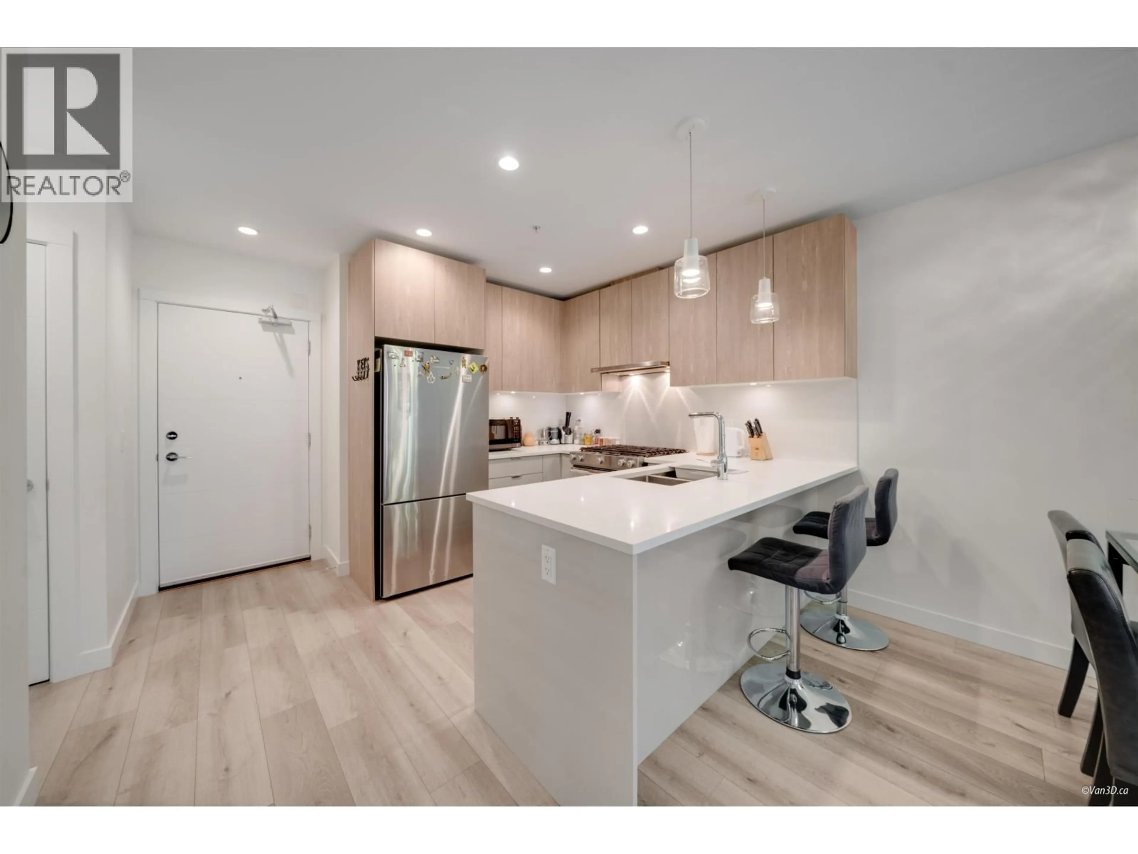 Open concept kitchen, wood/laminate floor for 207 - 128 8TH STREET, North Vancouver British Columbia V7L0H2
