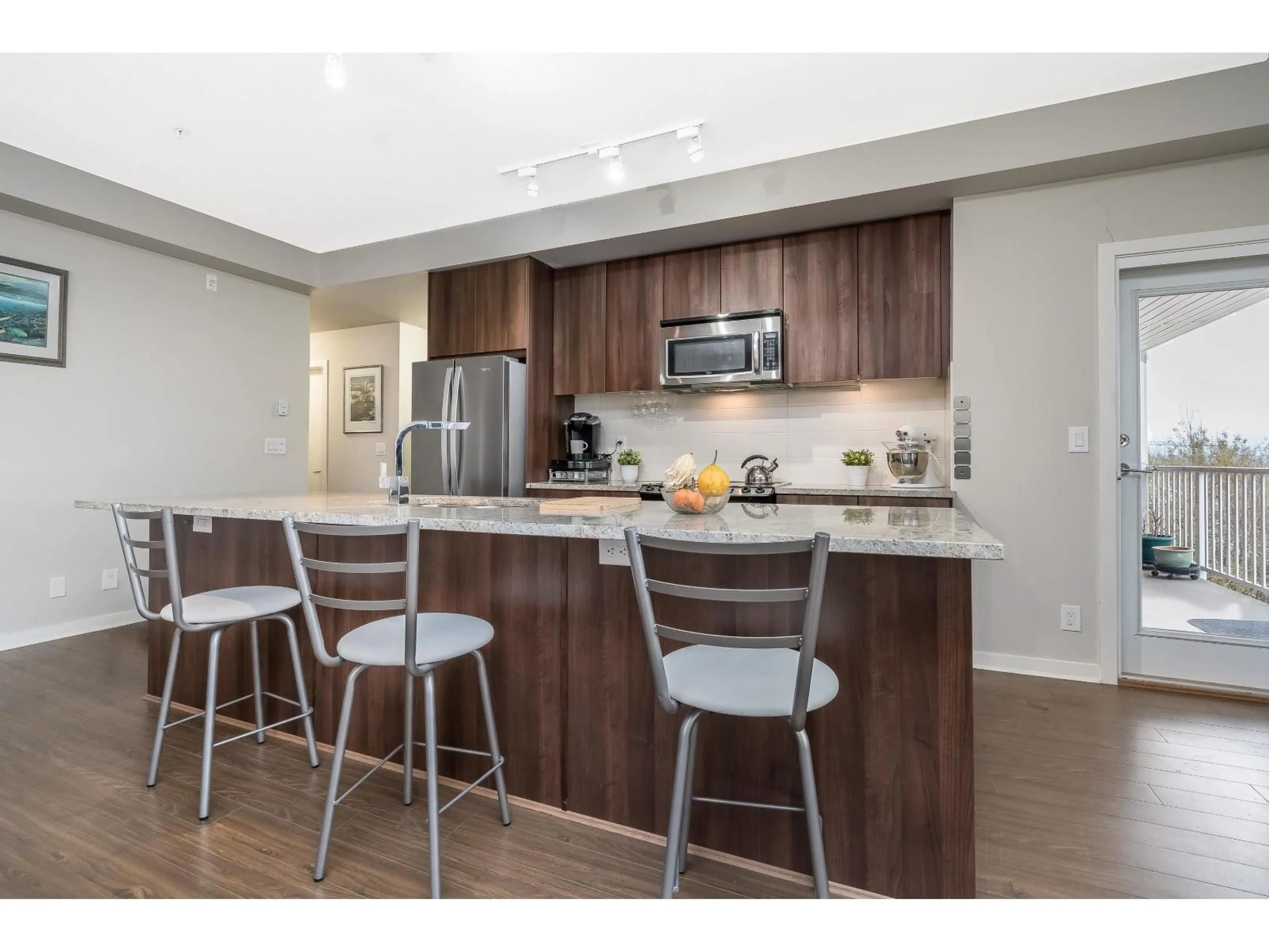 Open concept kitchen, wood/laminate floor for 307 - 6450 194 STREET, Surrey British Columbia V4N6J8