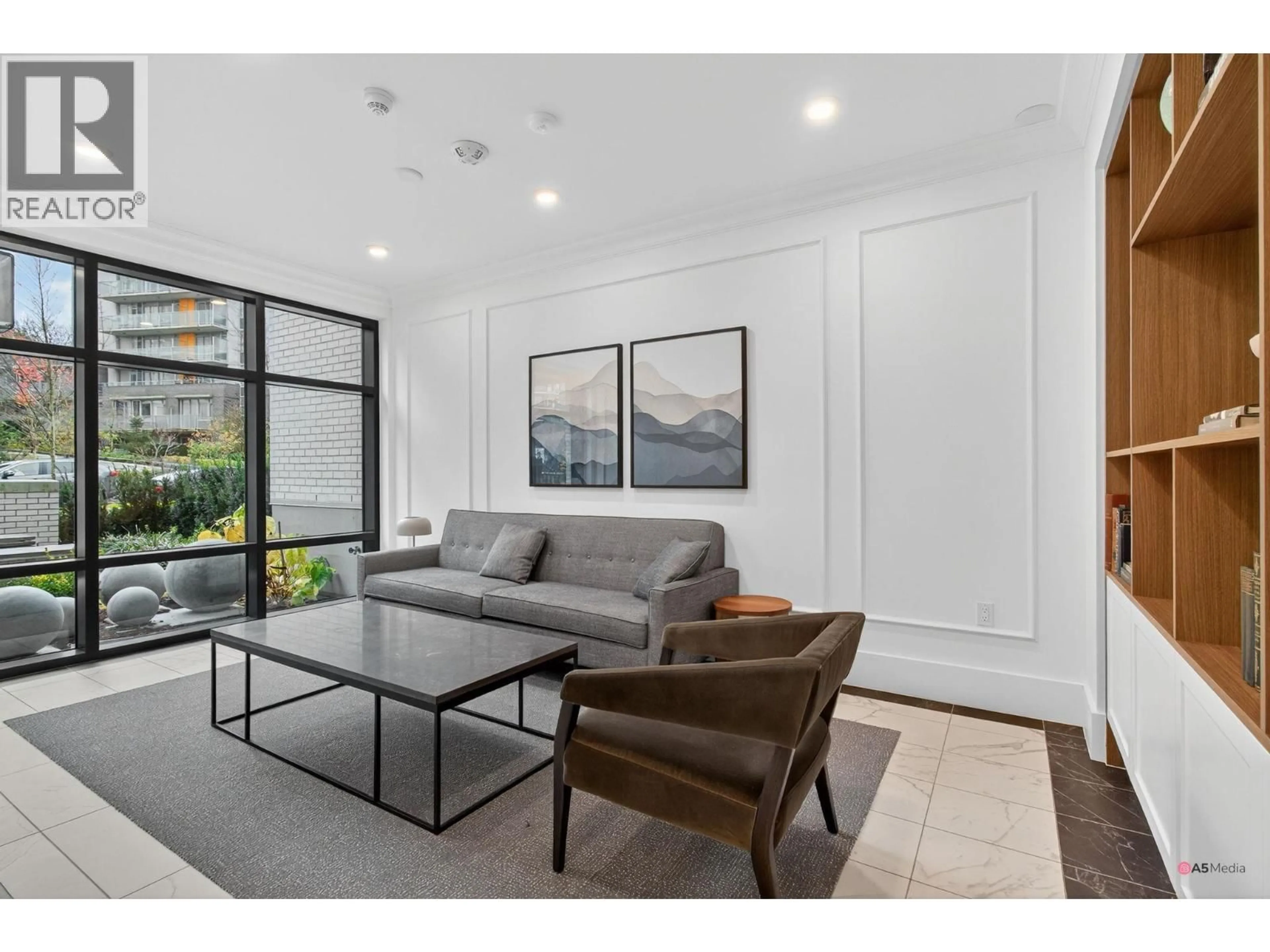 Living room with furniture, unknown for 702 - 8750 UNIVERSITY CRESCENT, Burnaby British Columbia V5A0G9