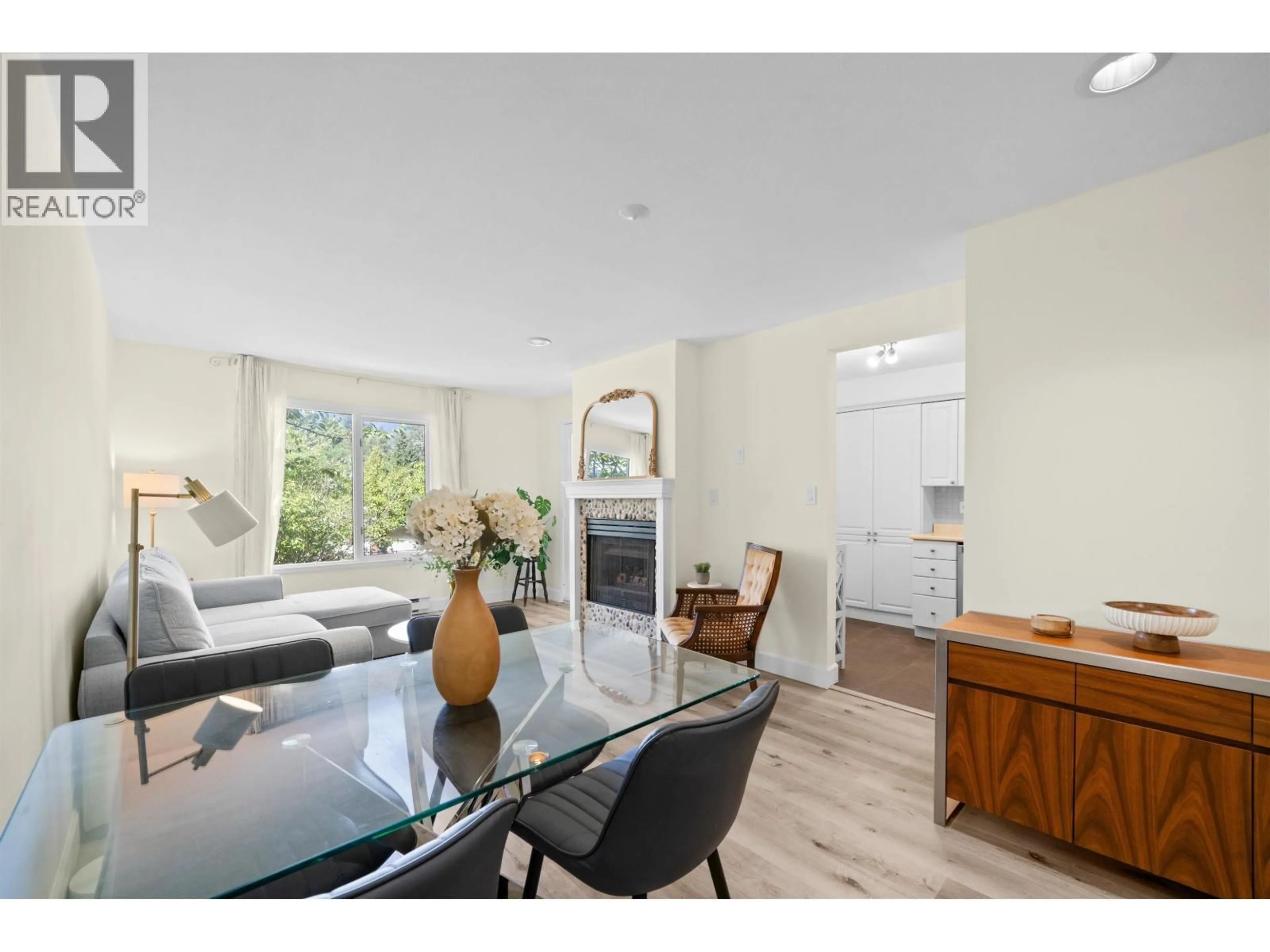 Living room with furniture, wood/laminate floor for 204 - 1528 BOWSER AVENUE, North Vancouver British Columbia V7P2Y3