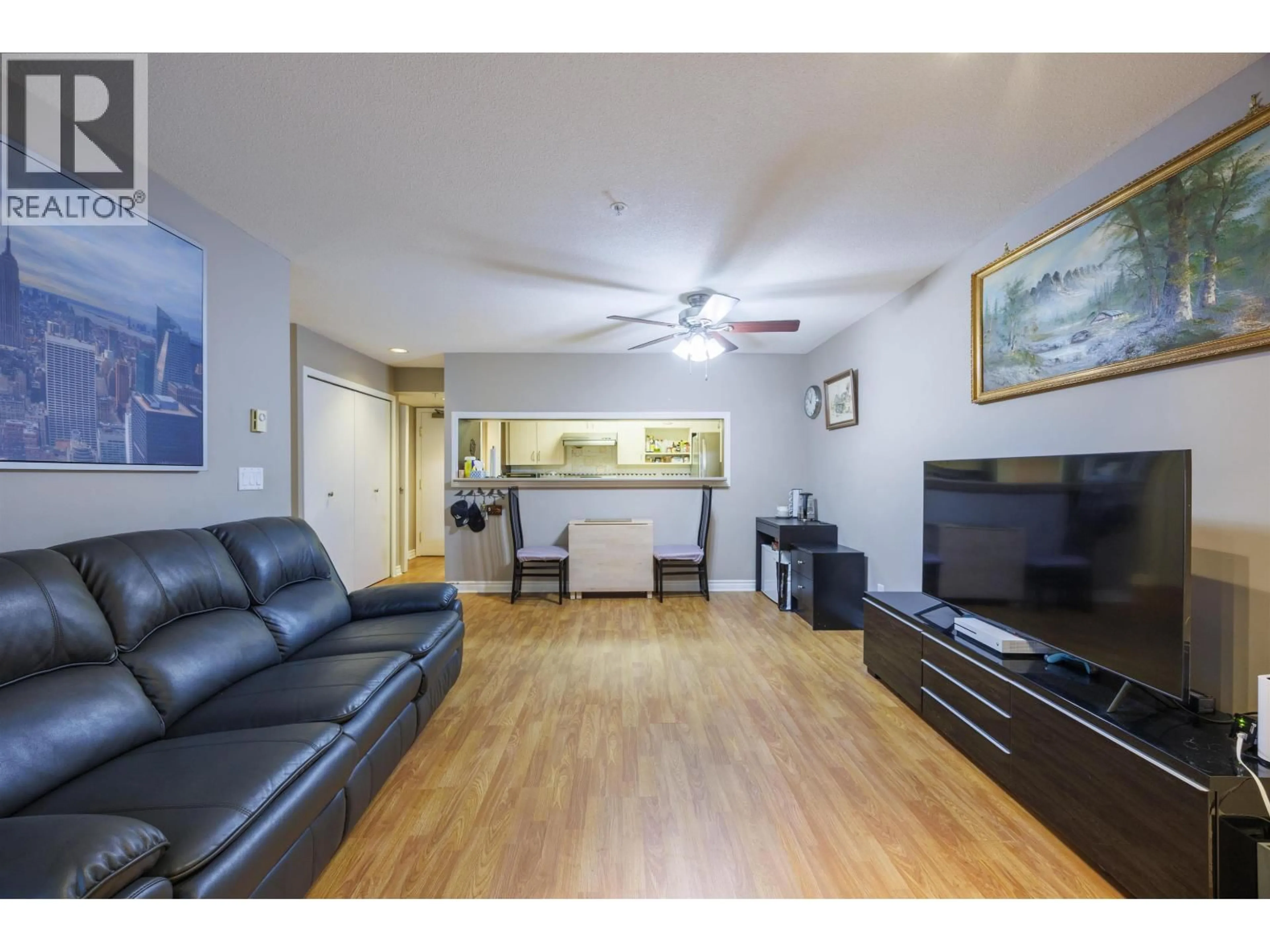 Living room with furniture, wood/laminate floor for 210 - 1163 THE HIGH STREET, Coquitlam British Columbia V3B7W2