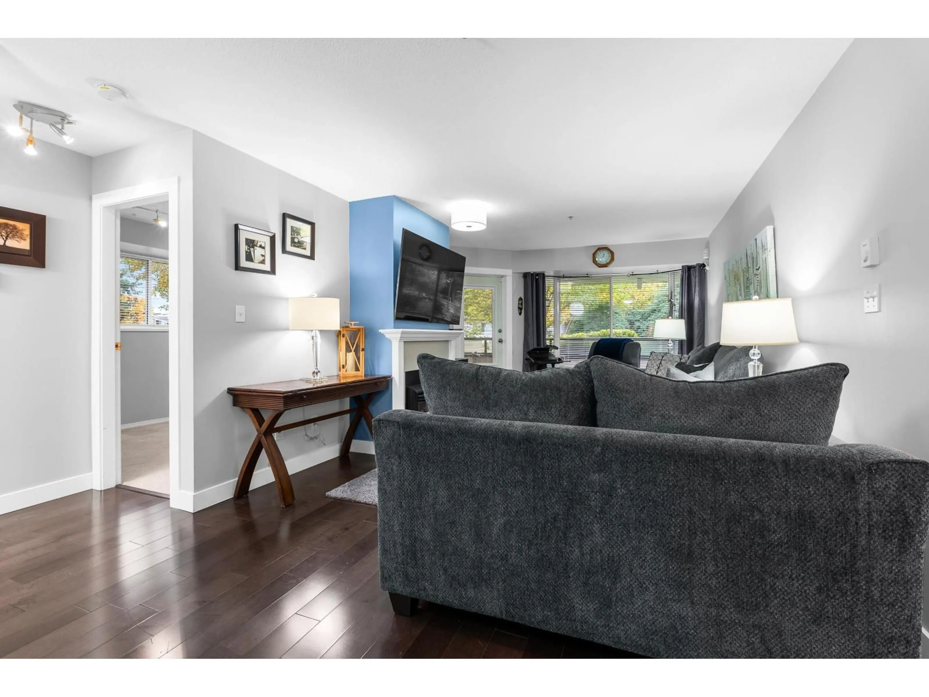 Living room with furniture, wood/laminate floor for 105 - 2964 TRETHEWEY STREET, Abbotsford British Columbia V2T6P4