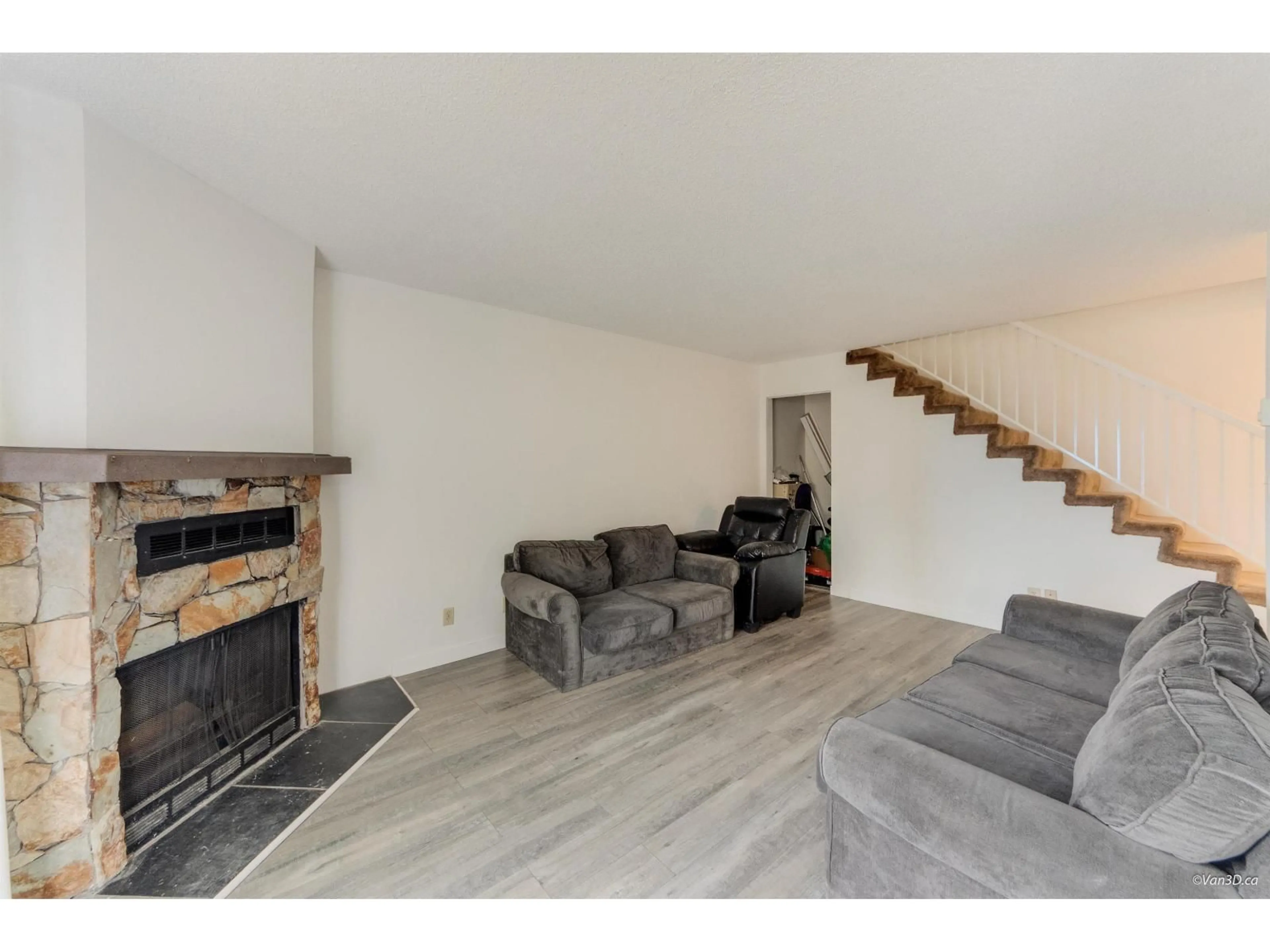 Living room with furniture, wood/laminate floor for 203 - 7162 133A STREET, Surrey British Columbia V3W7Z9