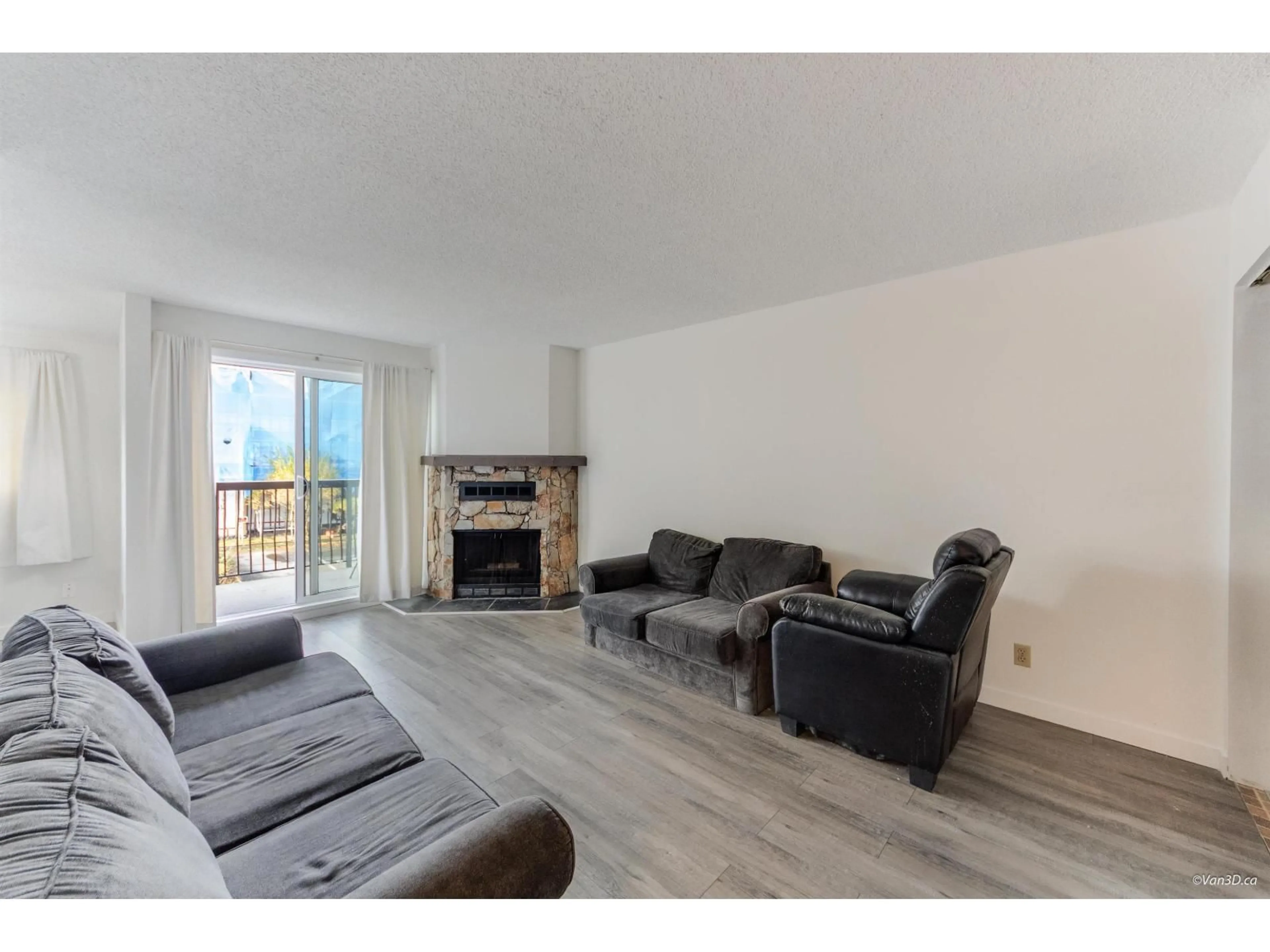 Living room with furniture, wood/laminate floor for 203 - 7162 133A STREET, Surrey British Columbia V3W7Z9
