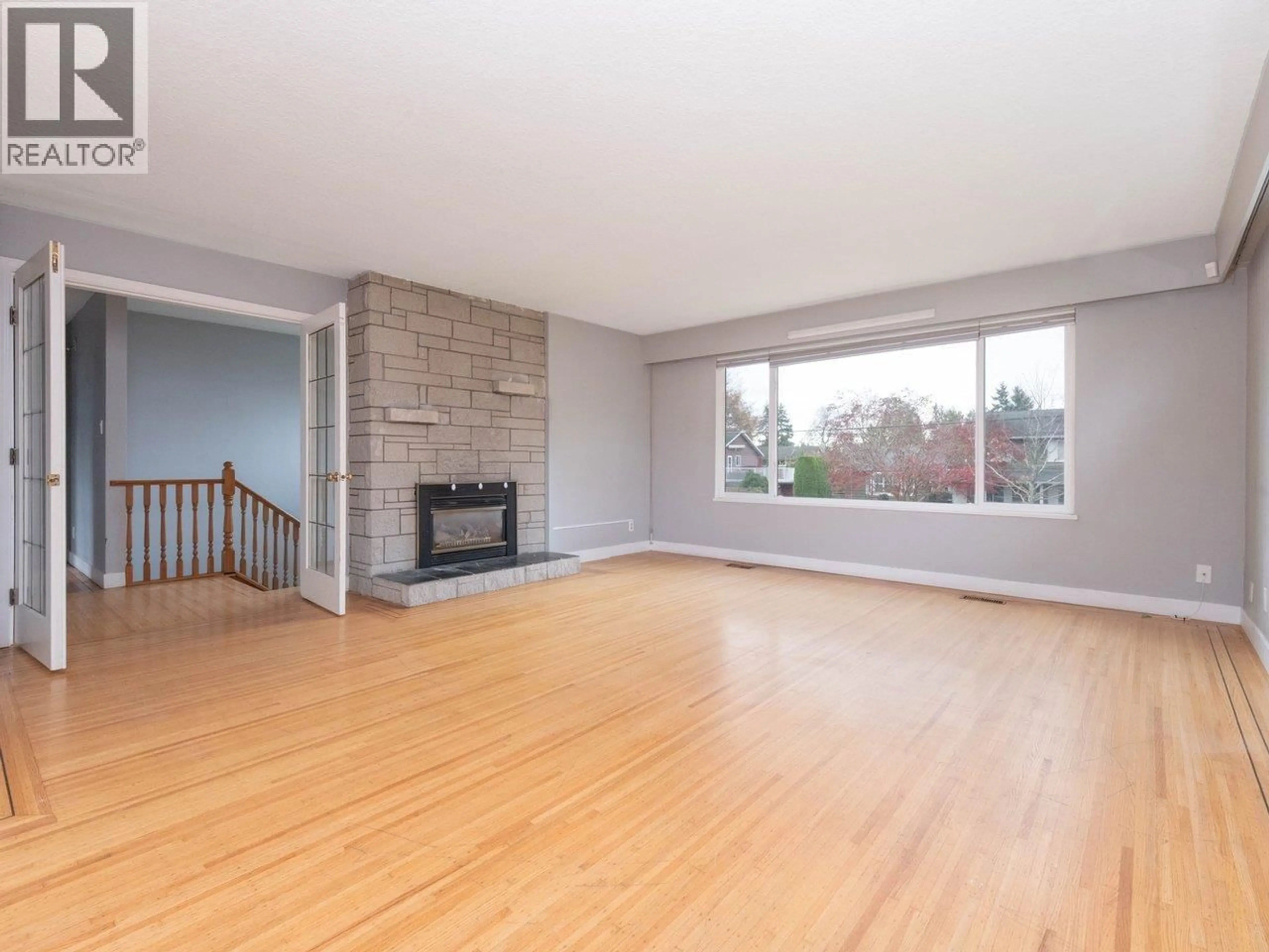Living room with furniture, wood/laminate floor for 5247 10A AVENUE, Delta British Columbia V4M1Y5