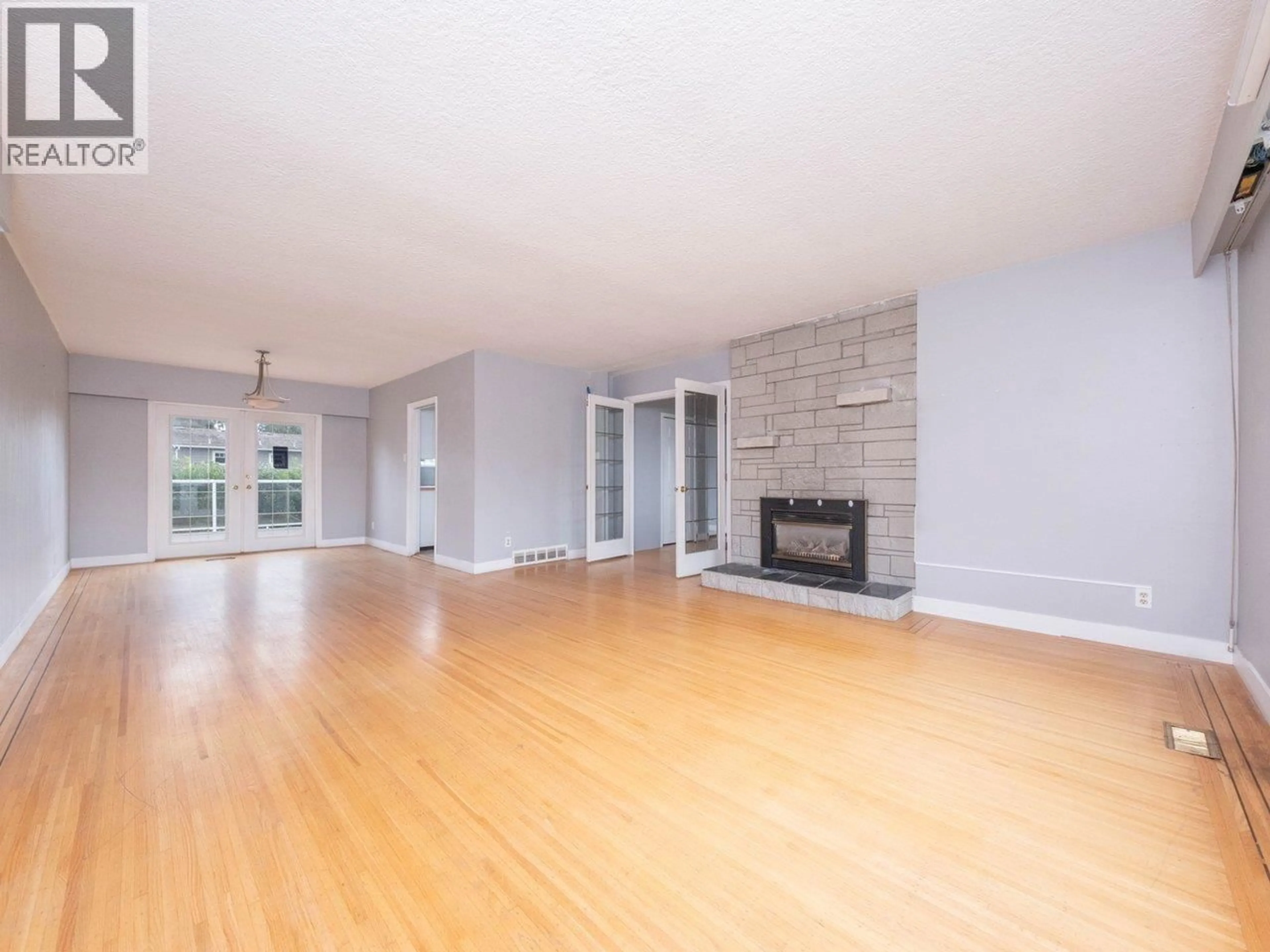 Living room with furniture, wood/laminate floor for 5247 10A AVENUE, Delta British Columbia V4M1Y5
