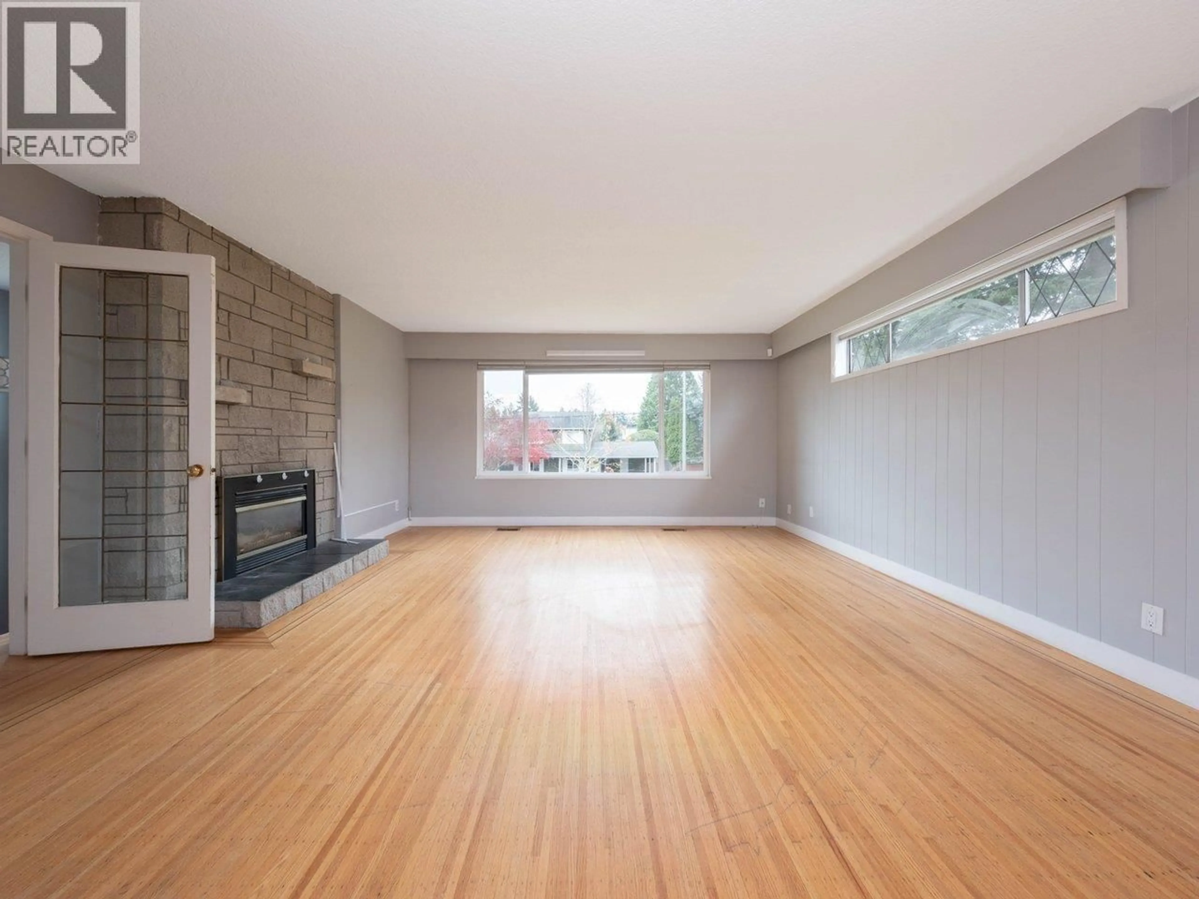 Living room with furniture, wood/laminate floor for 5247 10A AVENUE, Delta British Columbia V4M1Y5