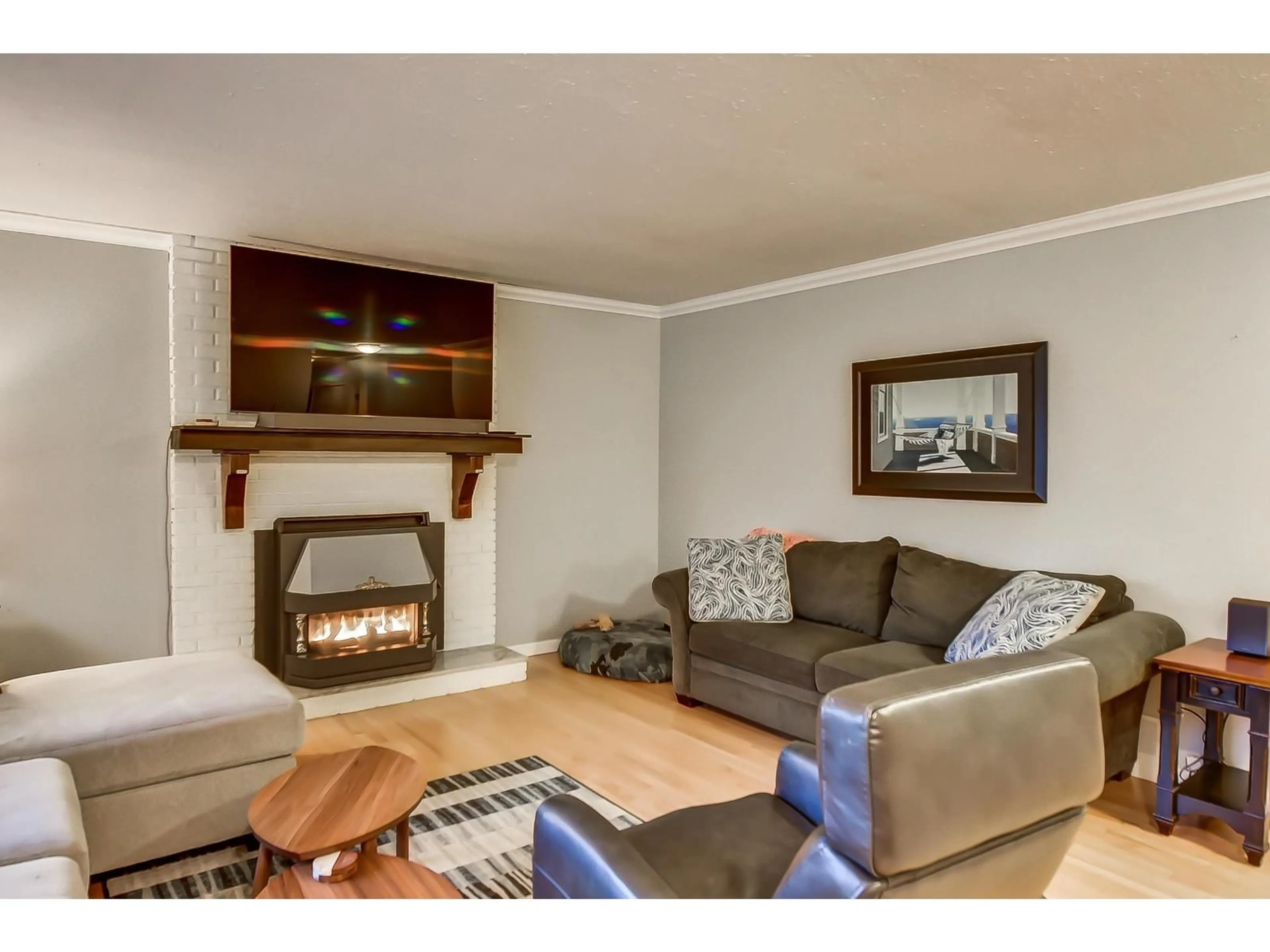 Living room with furniture, wood/laminate floor for 19735 48 AVENUE, Langley British Columbia V3A3L2