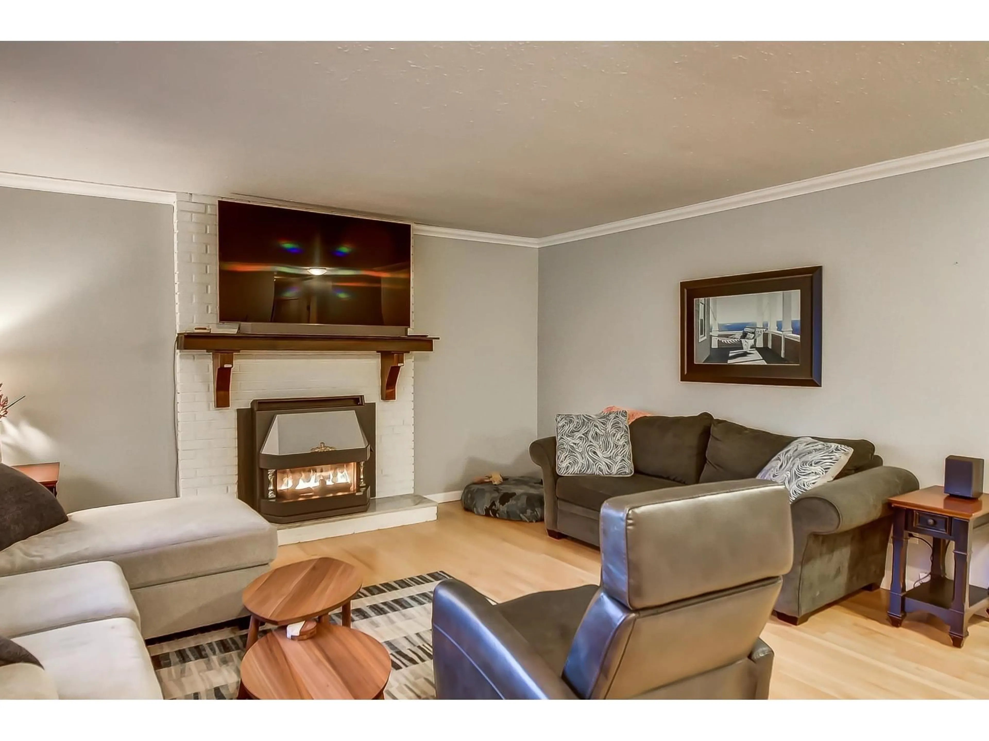 Living room with furniture, wood/laminate floor for 19735 48 AVENUE, Langley British Columbia V3A3L2