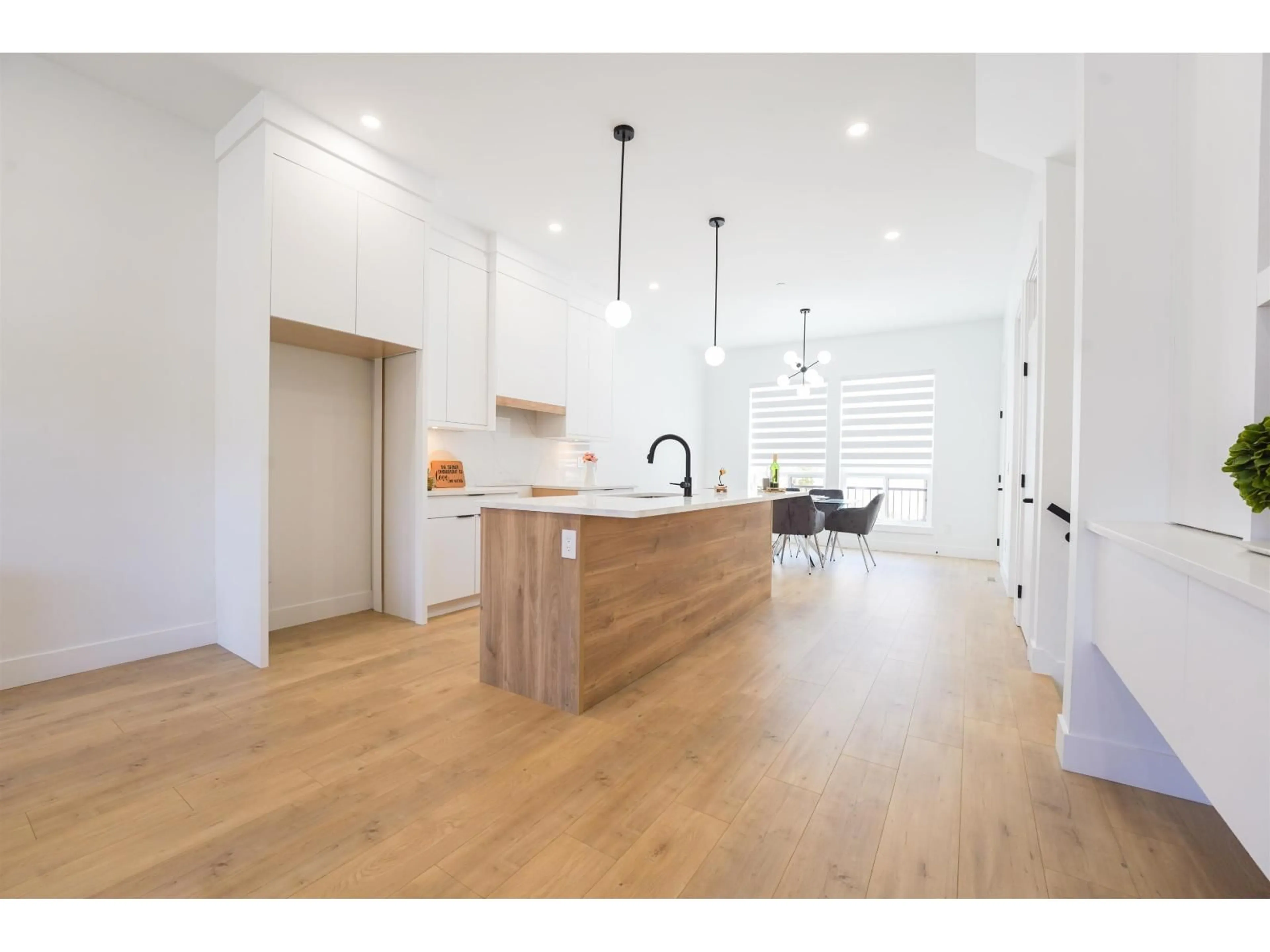 Open concept kitchen, wood/laminate floor for 20482 76 AVENUE, Langley British Columbia V3S2H2