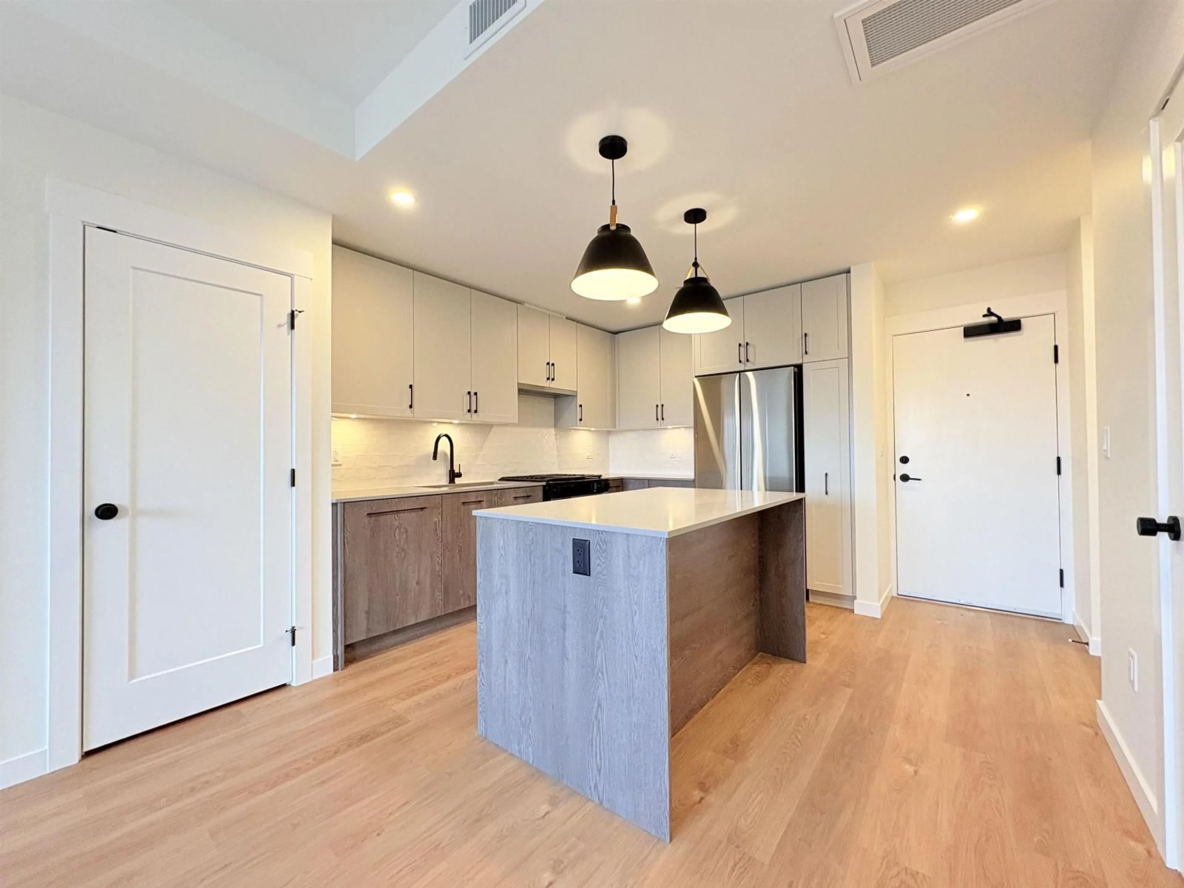 Open concept kitchen, wood/laminate floor for 203 - 27215 ALDERGROVE TOWN CENTRE DRIVE, Langley British Columbia V4W0E3