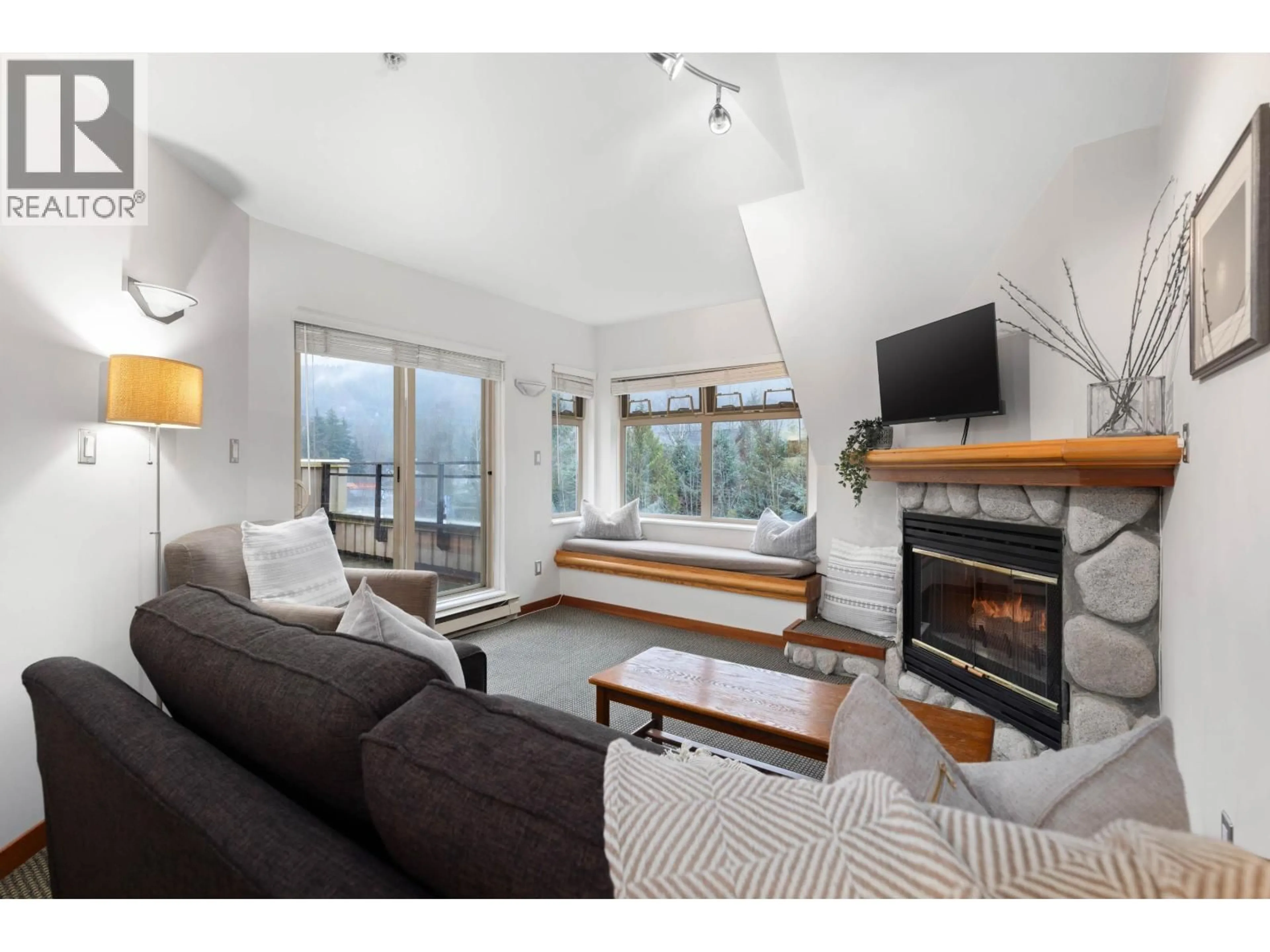 Living room with furniture, wood/laminate floor for 217 - 2050 LAKE PLACID ROAD, Whistler British Columbia V8E0A8
